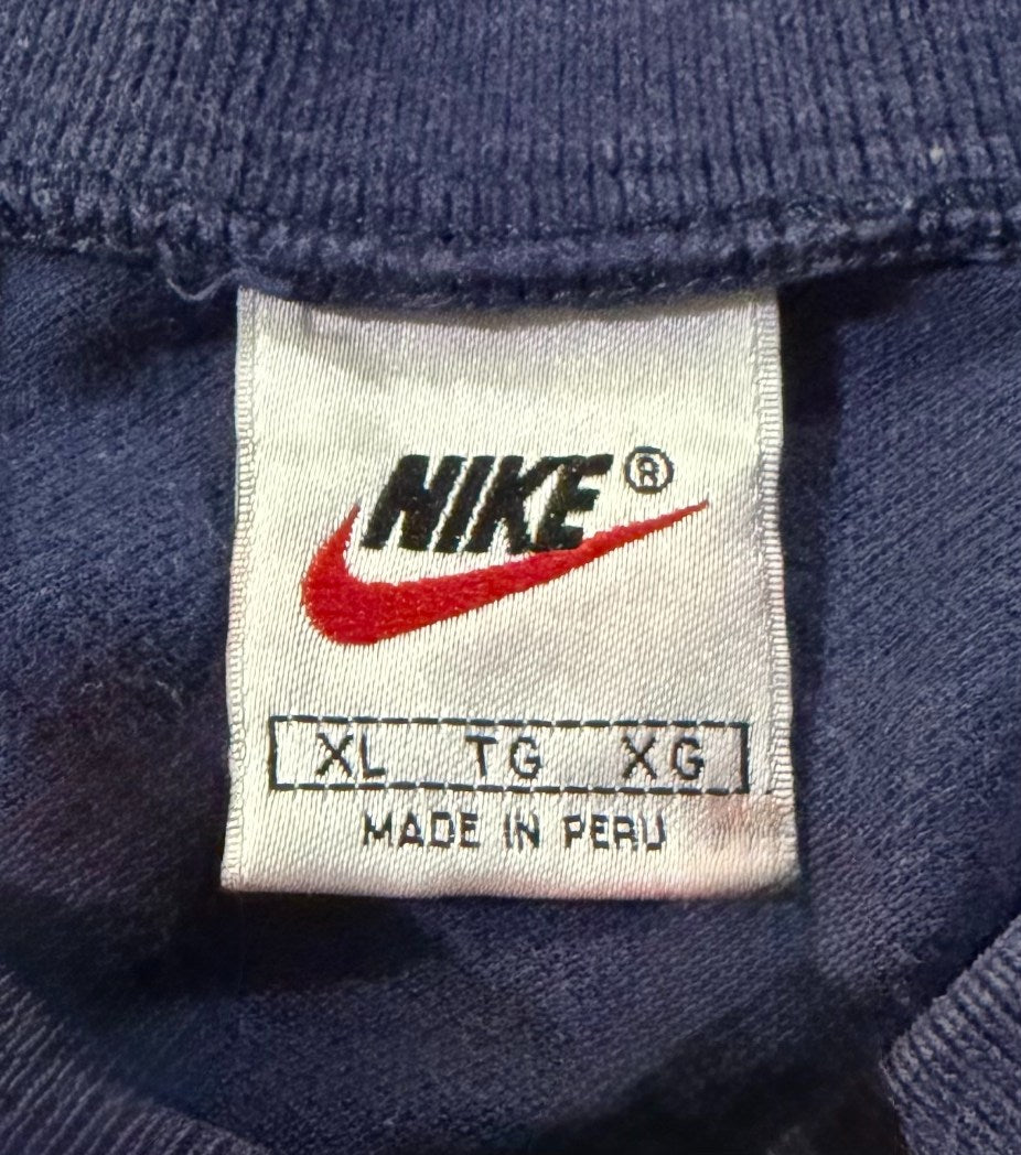 Close-up of neck tag on 1997 knit Nike t-shirt showing size XL