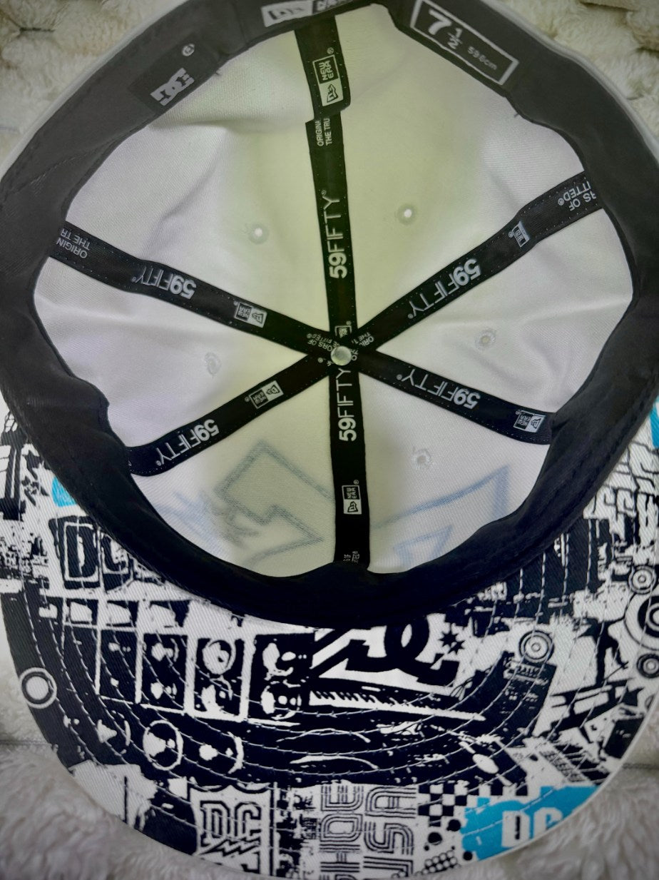 Interior view of vintage DC Shoes New Era 59FIFTY cap showing branded interior taping and black, white and blue graphic underside of brim.