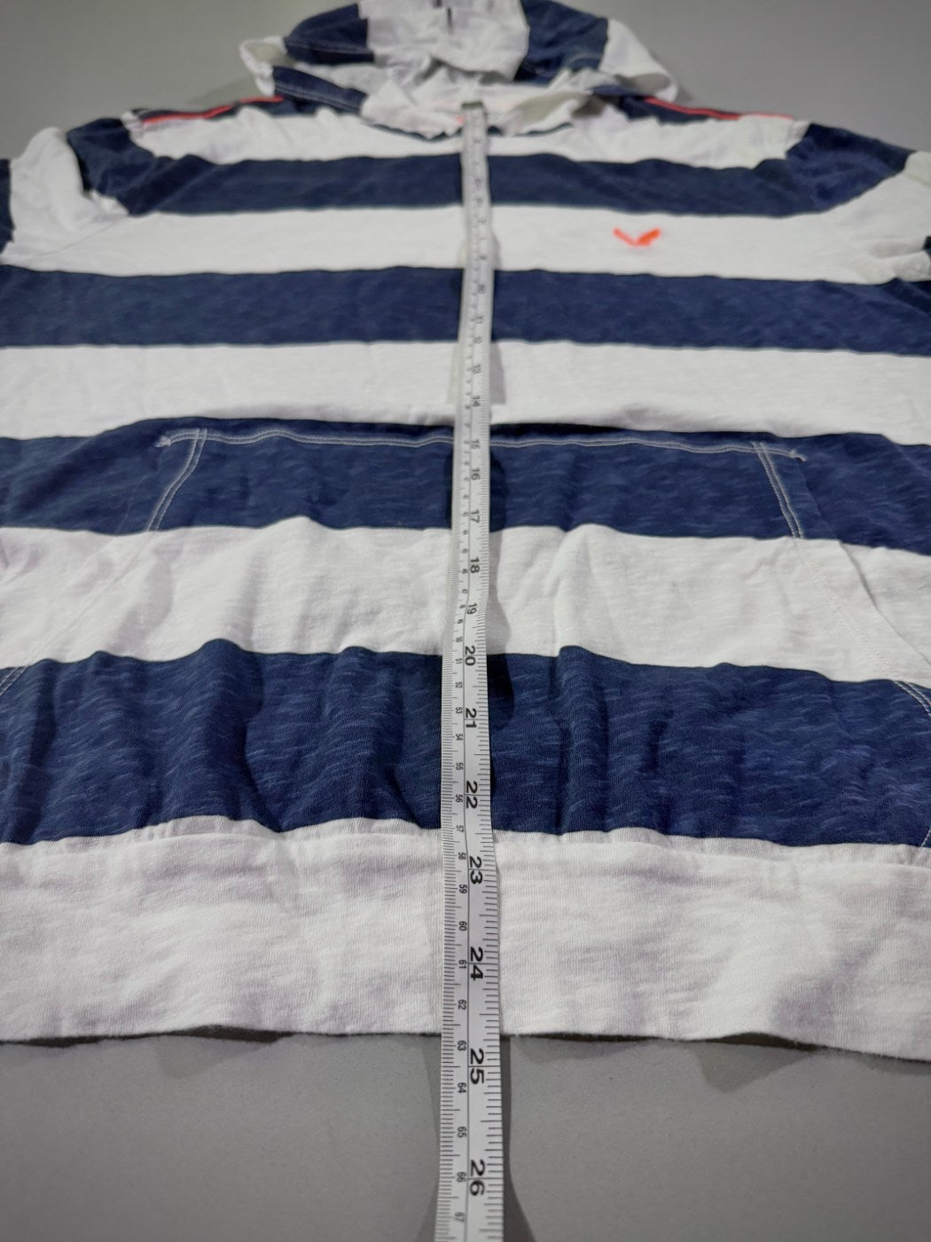 Close up of the length measurement on a navy & white striped American Eagle shirt from 2014. 