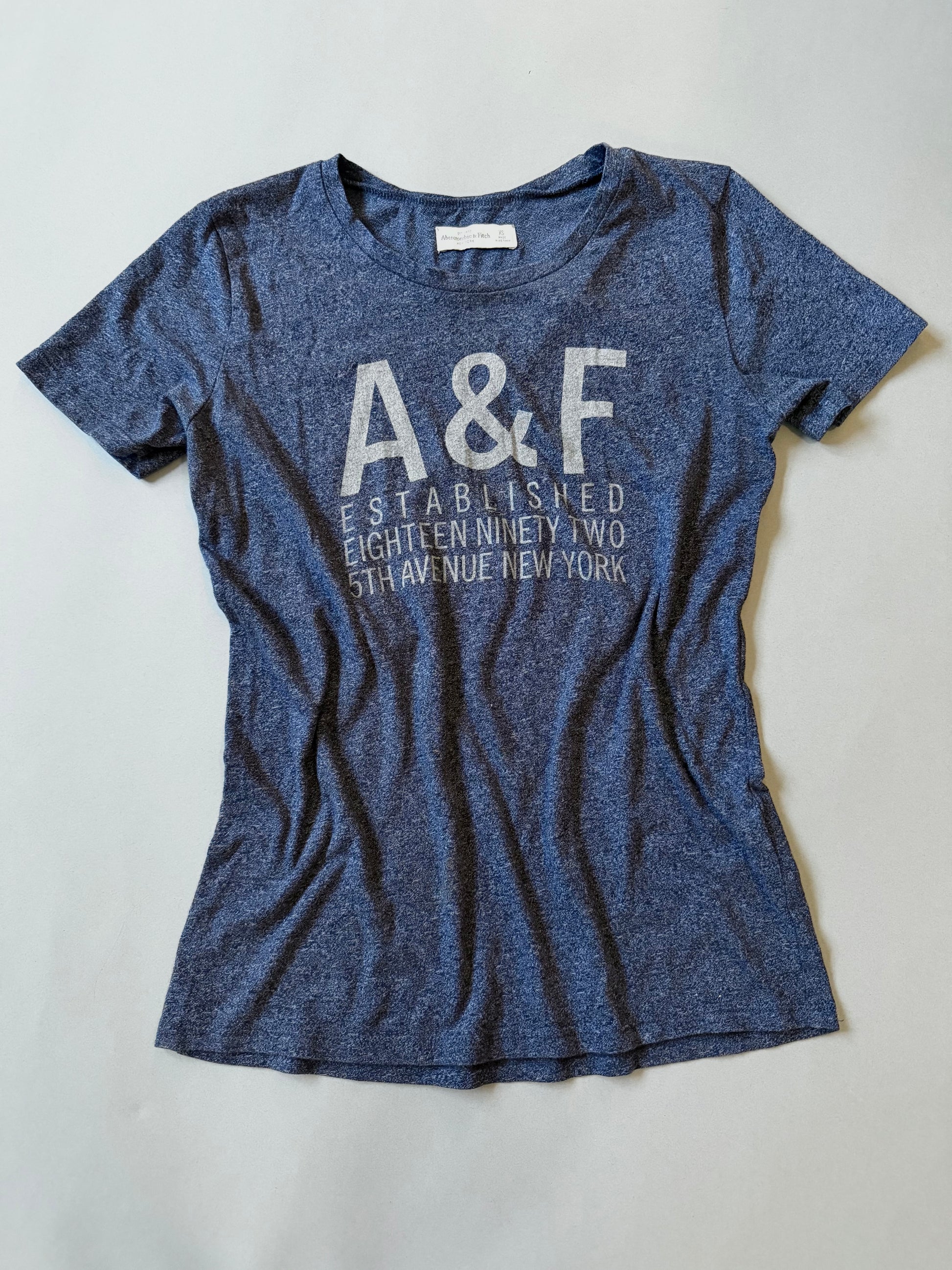 Navy blue Abercrombie & Fitch t-shirt with 'A&F' logo on a light gray background