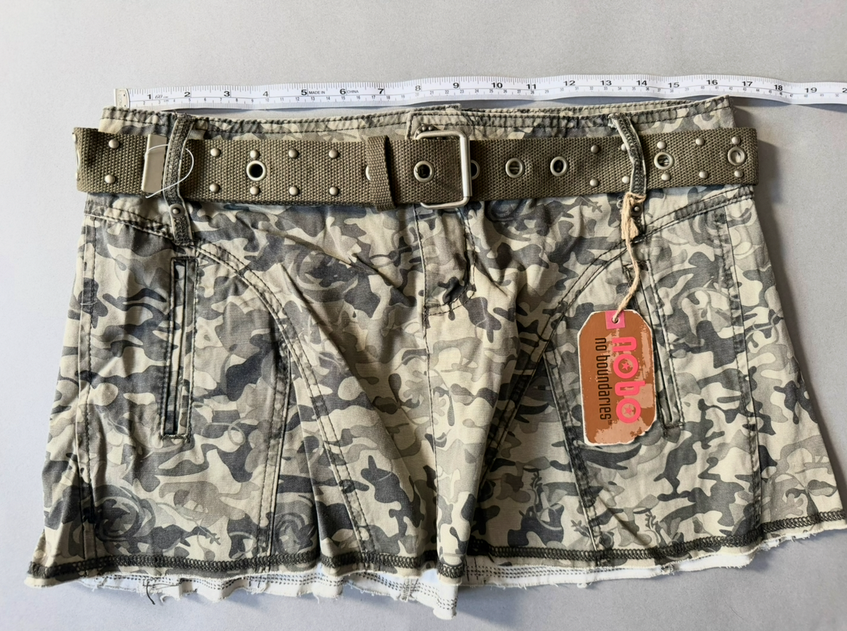Photo of 2007 vintage skirt with original tags and grommet stud belt measuring tape showing 33 inches waist