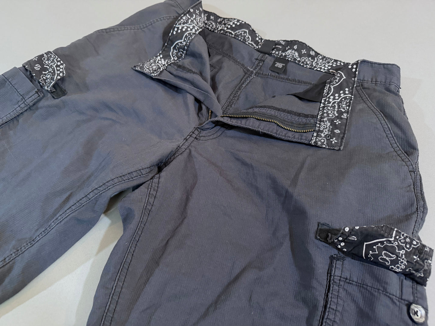 Close-up of the bandana print waistband and cargo pocket accents on International Concepts cargo shorts.
