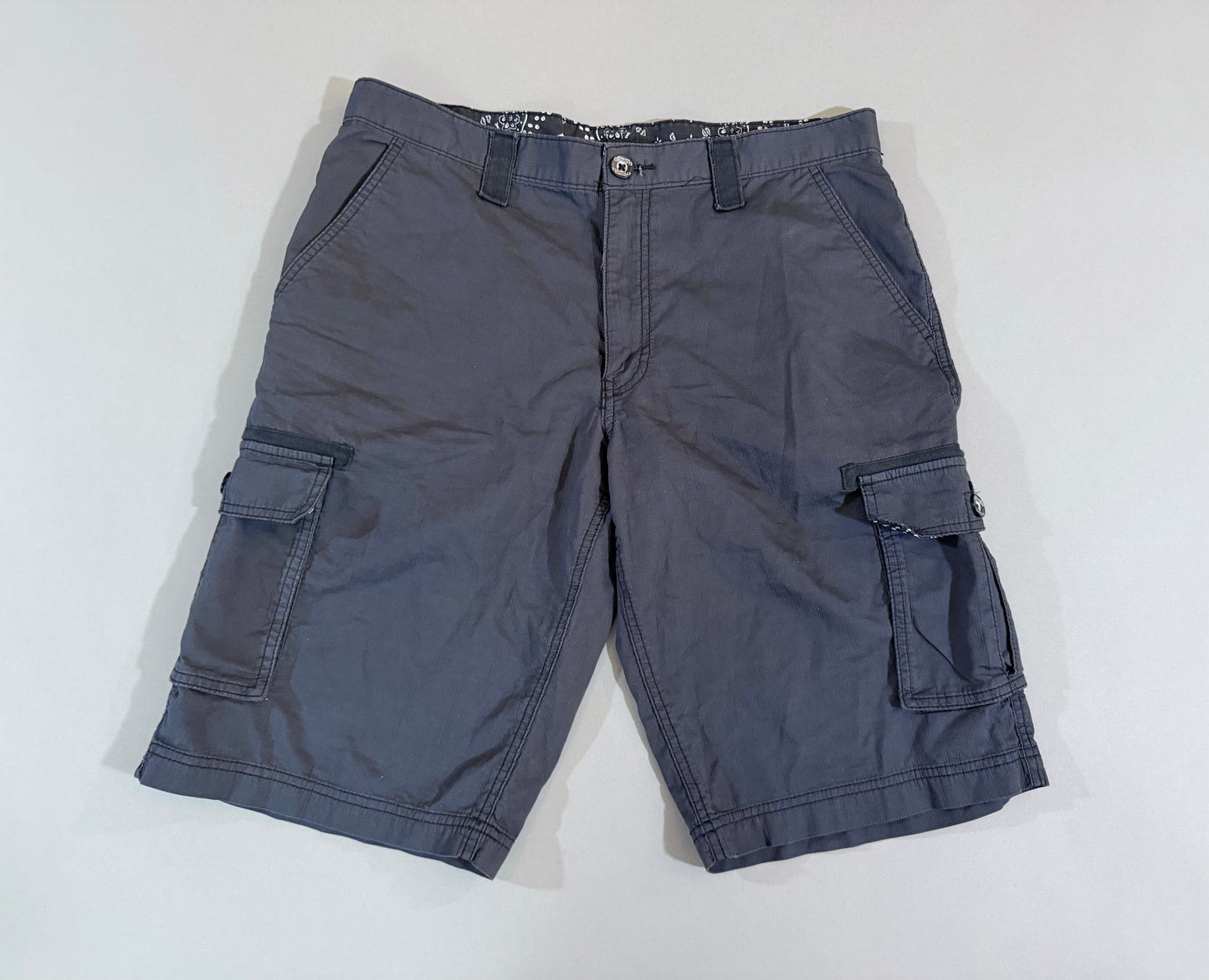 Front view of charcoal gray men’s cargo shorts with multiple utility pockets.