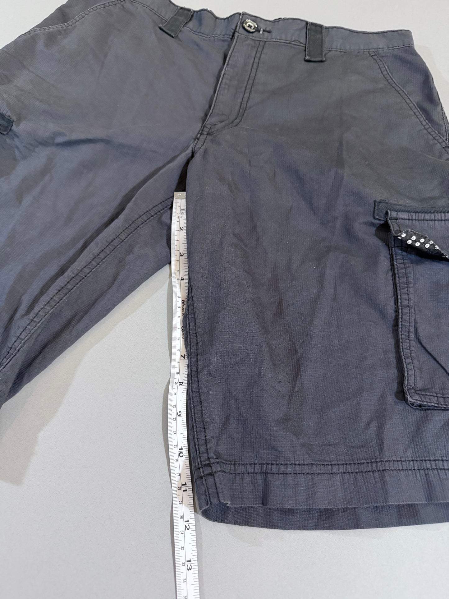 Inseam measurement of charcoal gray International Concepts cargo shorts.