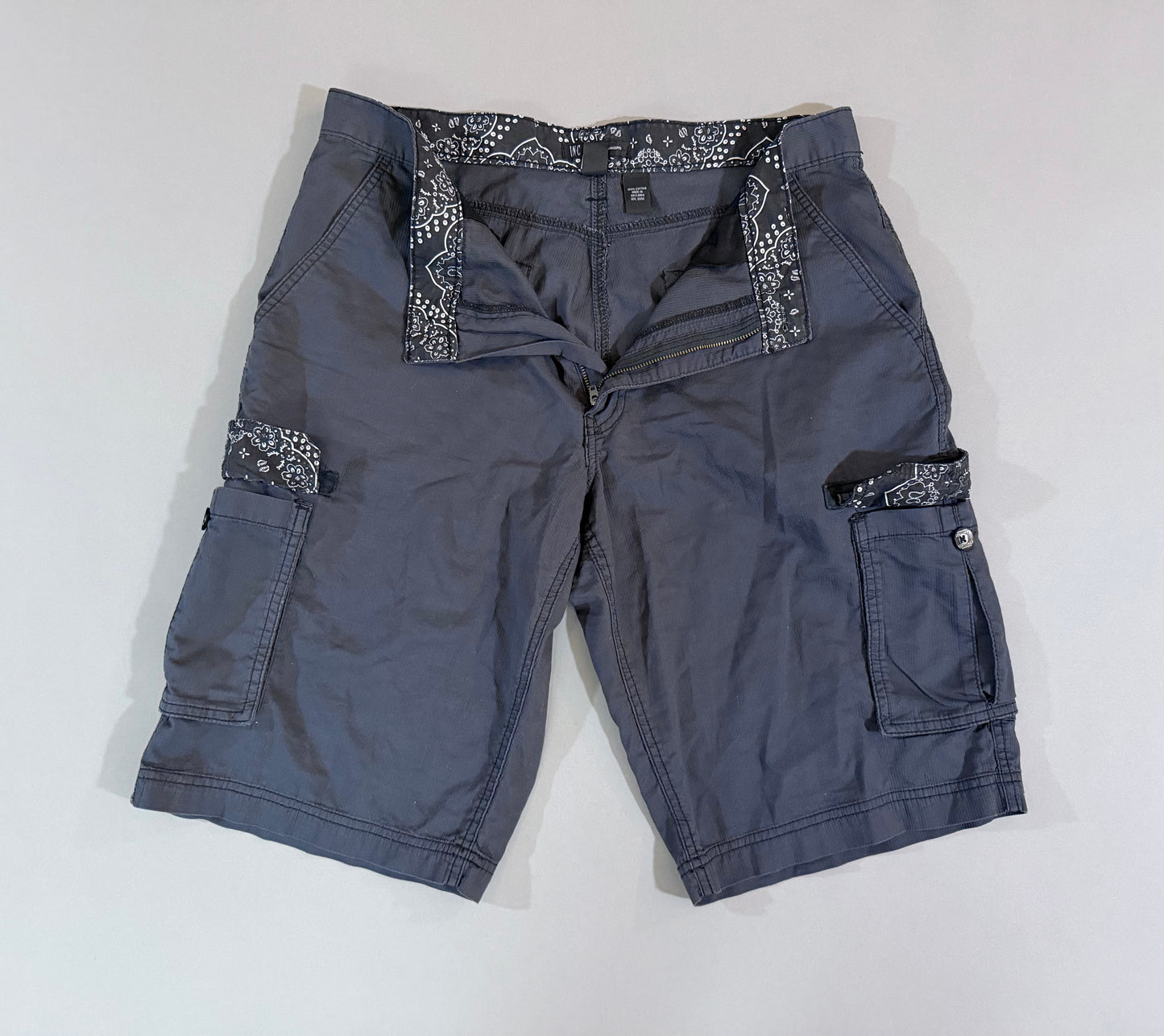     Front view of 2014 International Concepts charcoal gray cargo shorts with hidden paisley waistband trim.