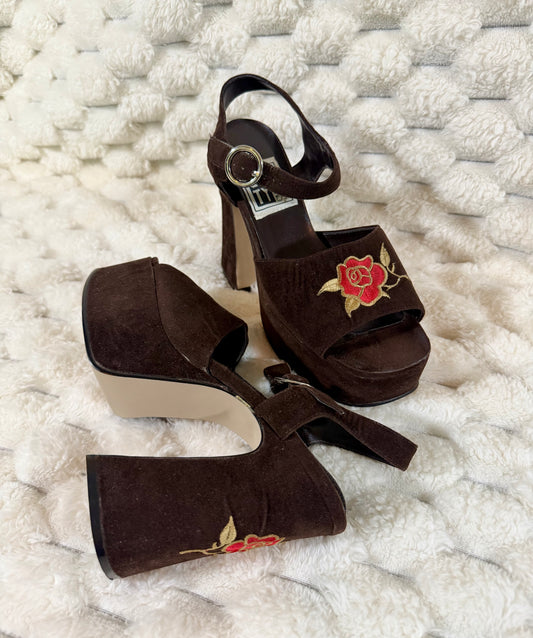 Vintage brown suede platform sandals featuring embroidered red roses, chunky heels, and ankle straps.