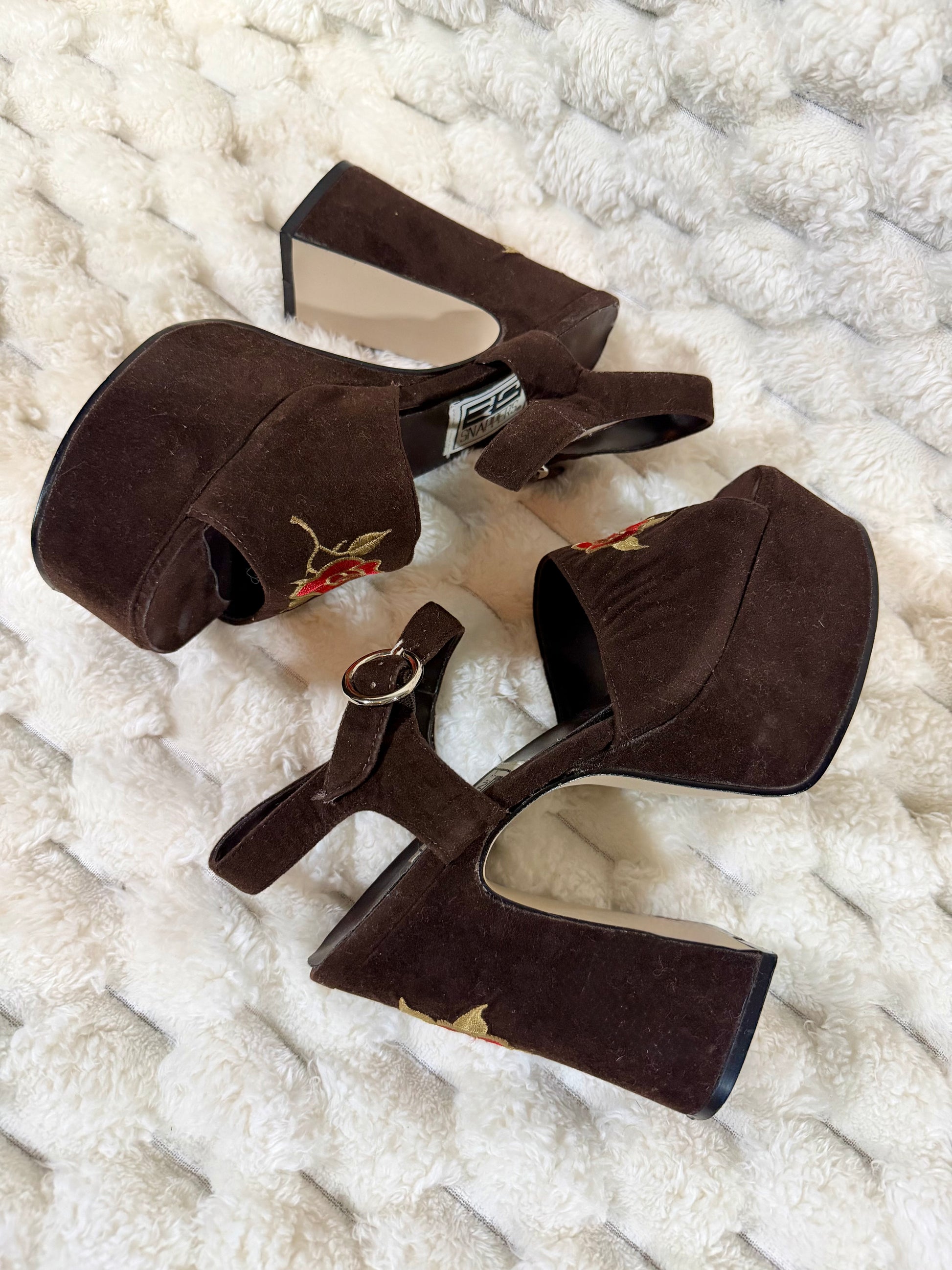 Top view of vintage brown platform sandals with floral embroidery and chunky block heels.