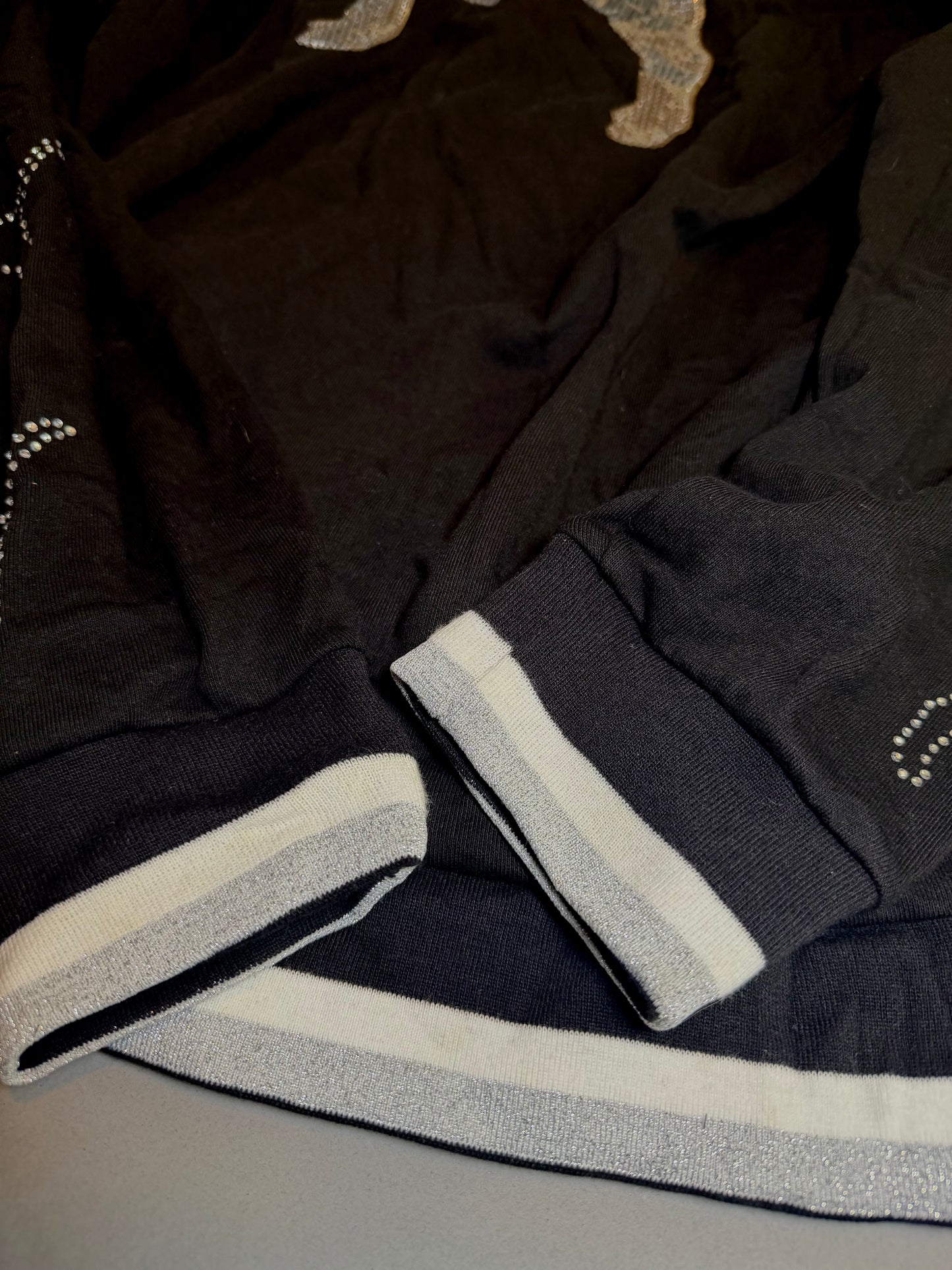 Metallic silver striped ribbed cuffs and waistband detail on the PINK hoodie.
