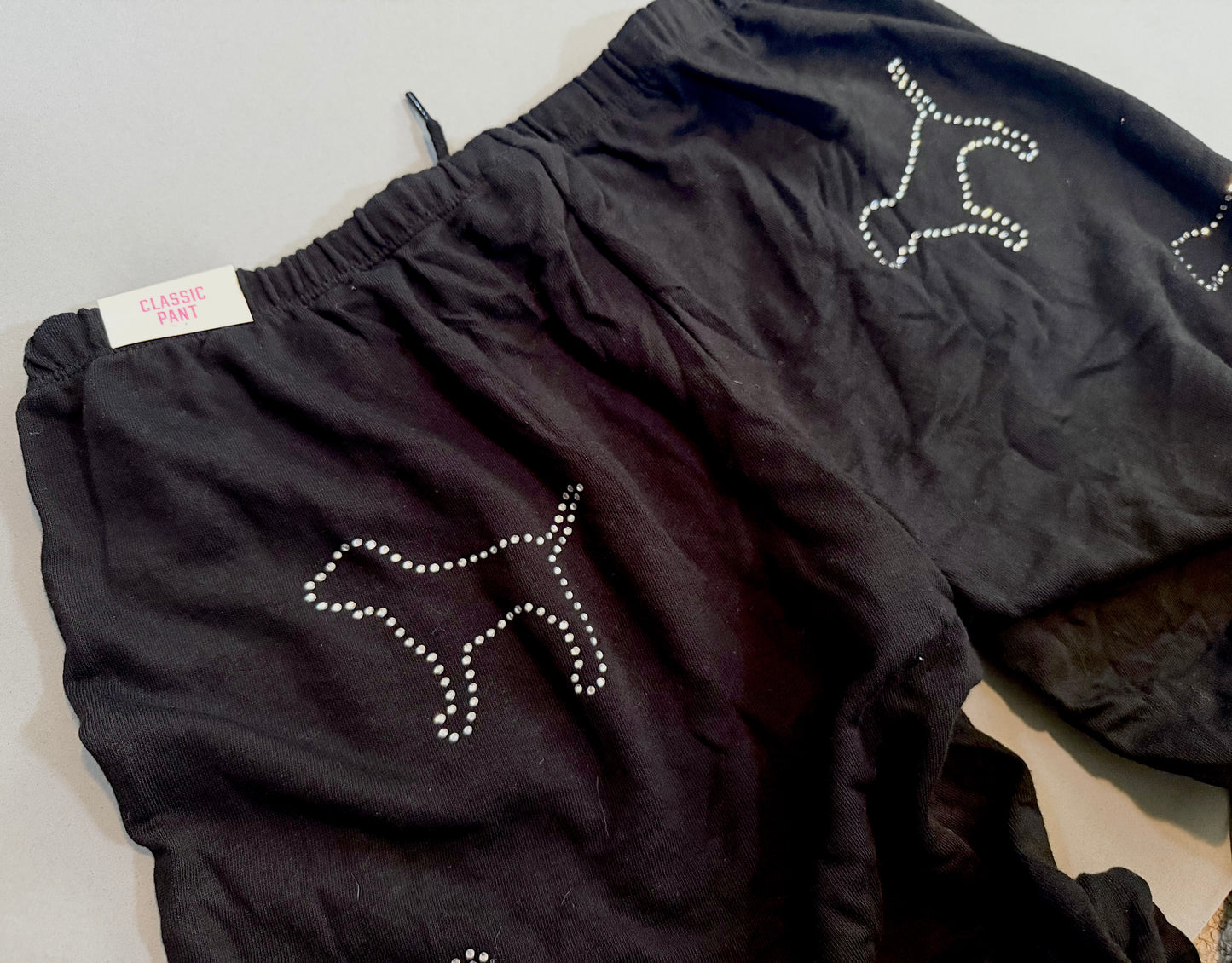 Close-up of the rhinestone dog graphic and original tag on the matching PINK sweatpants.