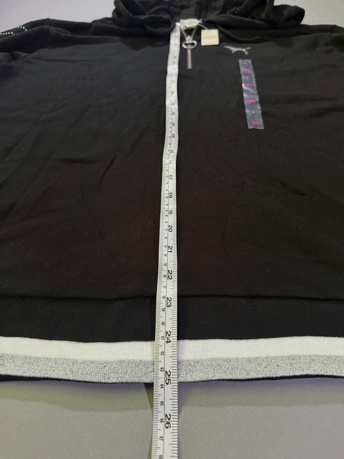 Flat lay VS PINK 1/4 zip sweater with measuring tape showing 25 inches length 