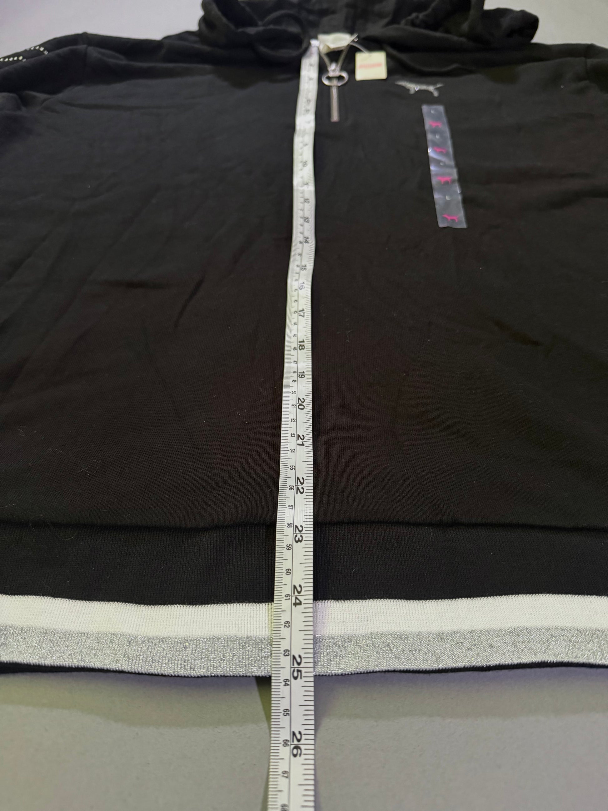 Flat lay VS PINK 1/4 zip sweater with measuring tape showing 25 inches length 
