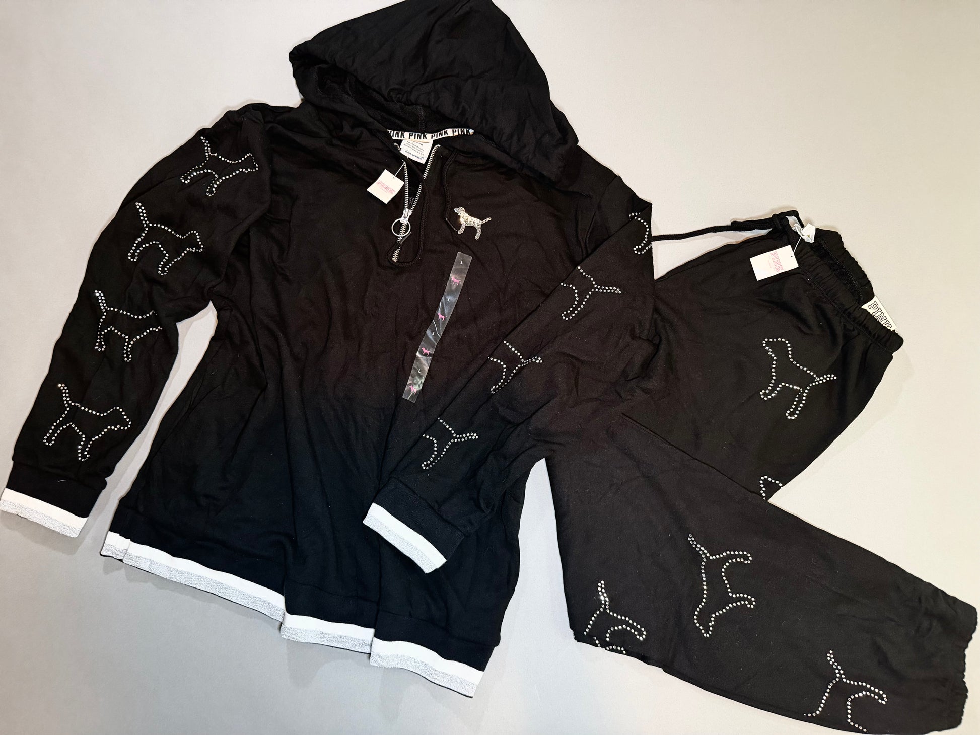 New with tags Victoria’s Secret PINK matching black hoodie and sweatpants set with rhinestone dog graphics.