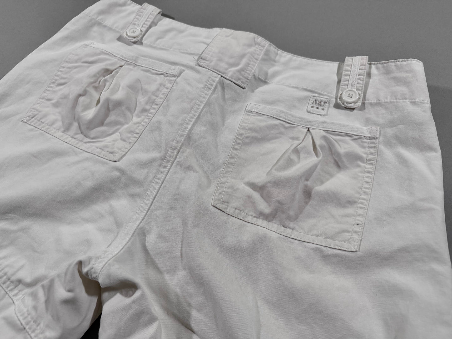 Close-up of the back waistband on vintage Abercrombie & Fitch cargo pants showing rear pockets, belt loops, and embroidered A&F logo tab.