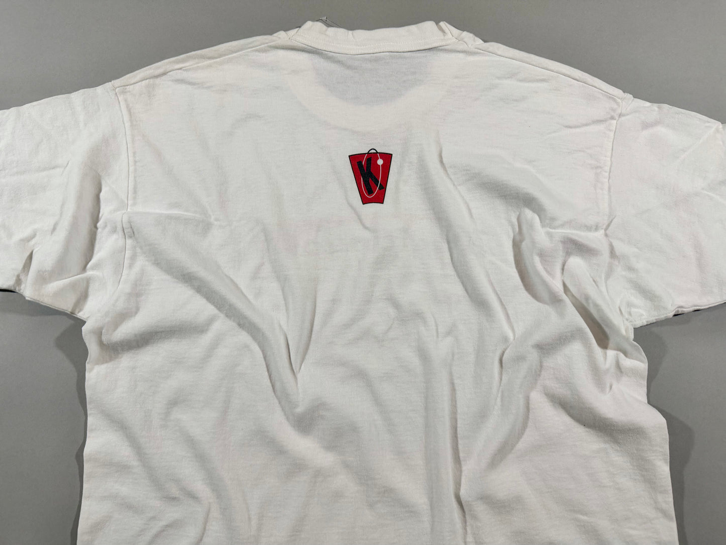Back view of vintage Kryptonics white T-shirt featuring small red and black logo below the collar.