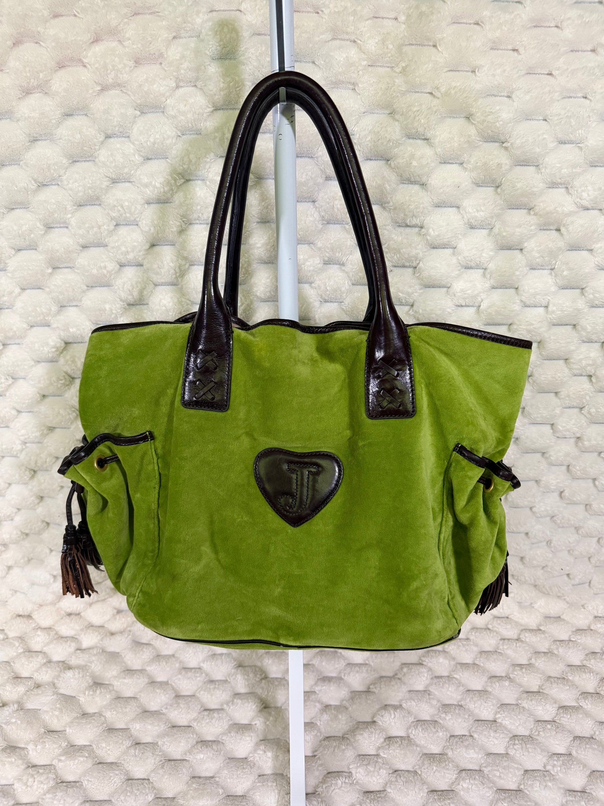 Back of vintage Juicy Couture green velour Splendor tote with brown leather-look trim, side pockets and heart logo patch.