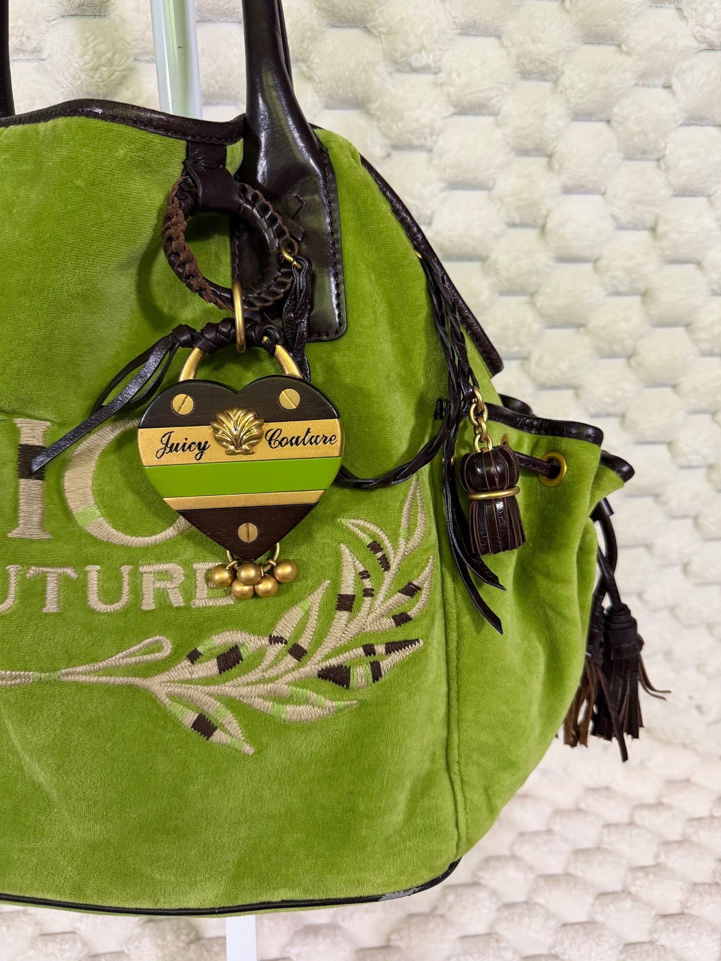 Vintage Juicy Couture heart bag charm in green, brown and gold with logo plaque, shell detail and dangling gold beads.