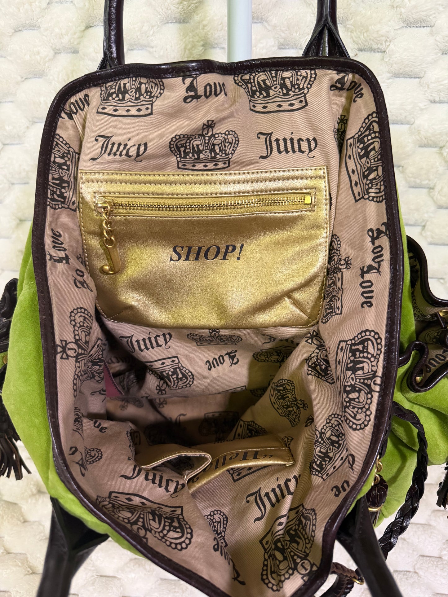 Interior of vintage Juicy Couture velour tote with crown-print lining and metallic gold SHOP zip pocket with J zipper pull.
