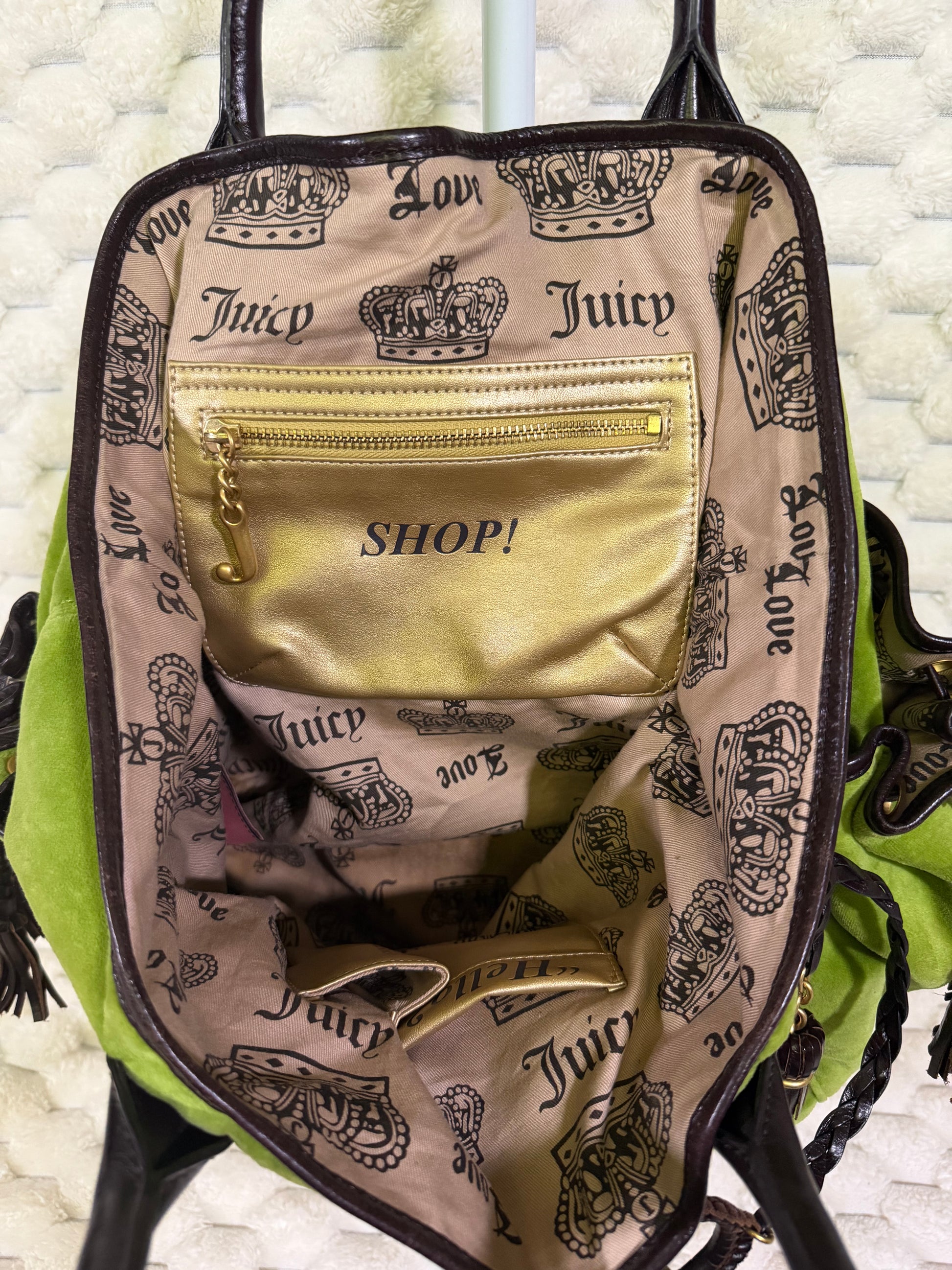 Interior of vintage Juicy Couture velour tote with crown-print lining and metallic gold SHOP zip pocket with J zipper pull.
