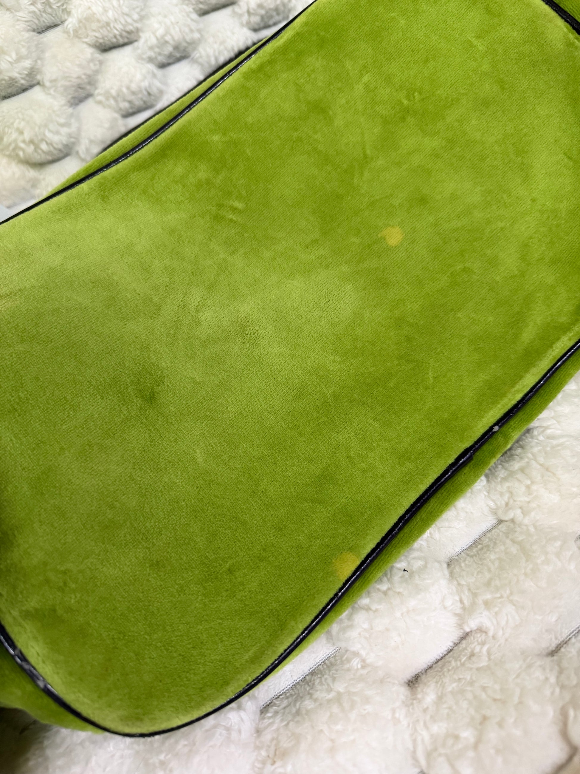 Bottom of vintage Juicy Couture green velour bag showing small discoloration spots and brown piping.
