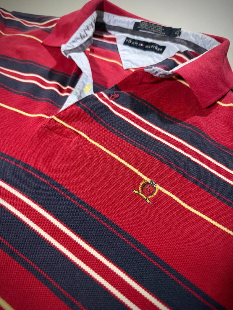 Angled photo of 2001 Tommy Hilfiger polo shirt, with chambray lining on the collar and crest embroidered on left breast. 