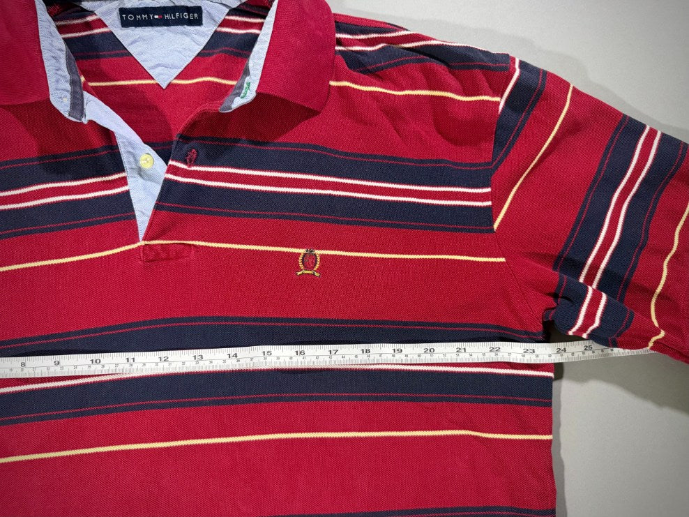 Measuring tape showing 23.5 inches pit to pit on vintage Tommy Hilfiger shirt. 