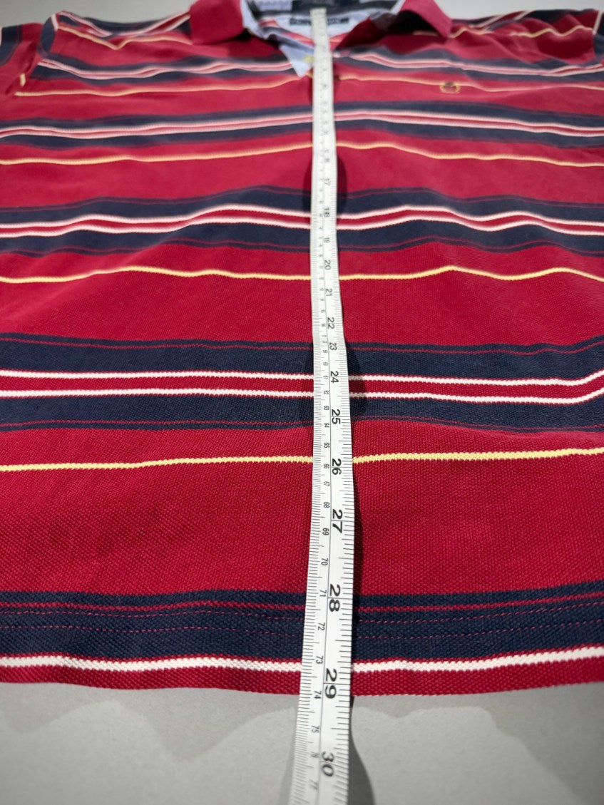 Measuring tape showing 29 inches length on striped polo. 