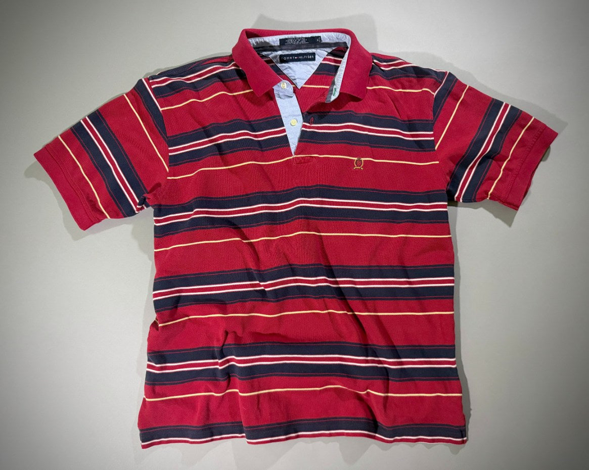Photo of vintage Tommy Hilfiger polo t-shirt with red, white, blue, and skinny yellow stripes. 
