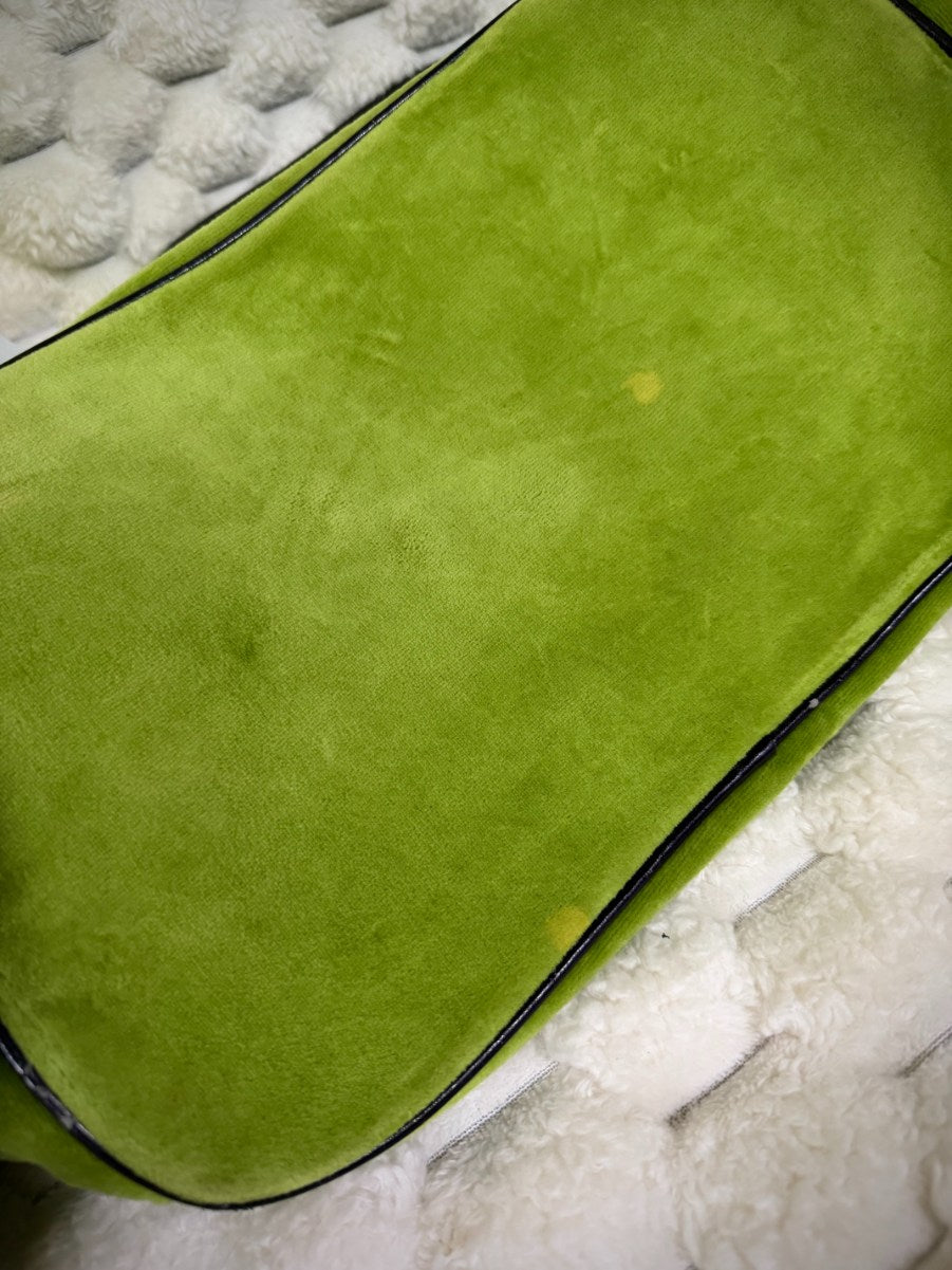 Bottom of vintage Juicy Couture green velour bag showing small discoloration spots and brown piping.