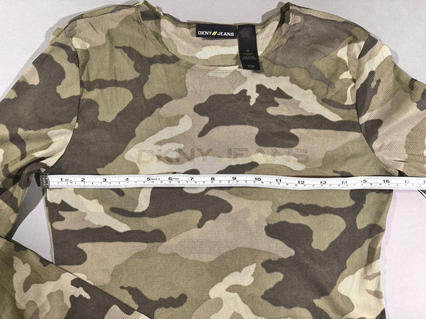2000s DKNY shirt with measuring tape showing 16.5 inches pit to pit