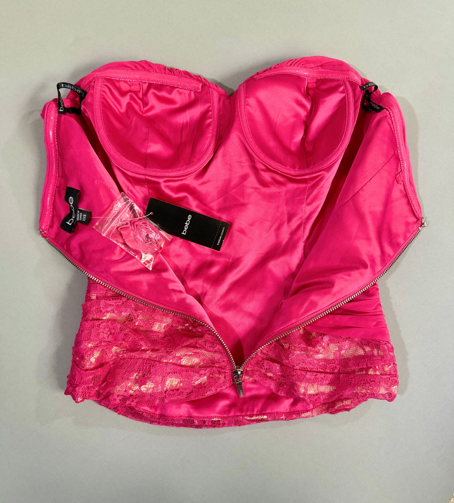 Interior view showing the satin lining, structured underwire cups, attached tags, and packaged removable straps.