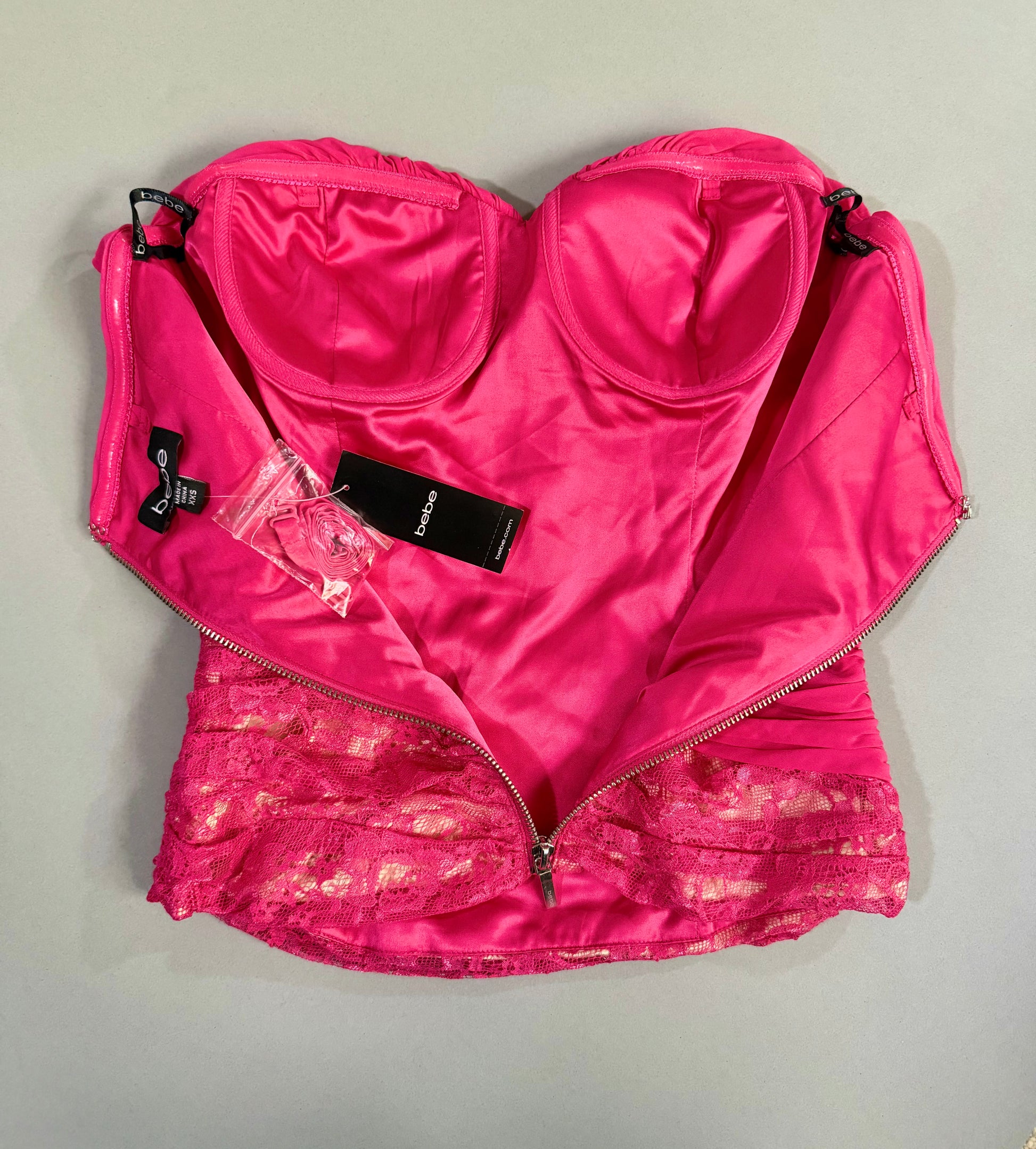Interior view showing the satin lining, structured underwire cups, attached tags, and packaged removable straps.