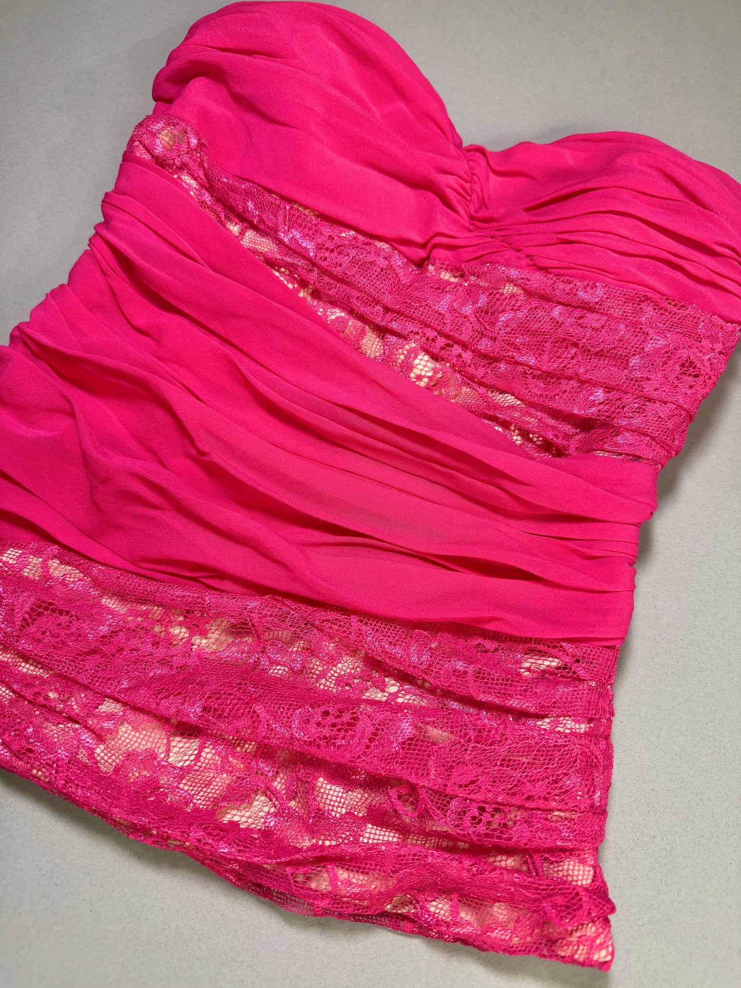 Close-up of the front bodice showing the sweetheart neckline, ruched chiffon, and floral lace panel detailing.