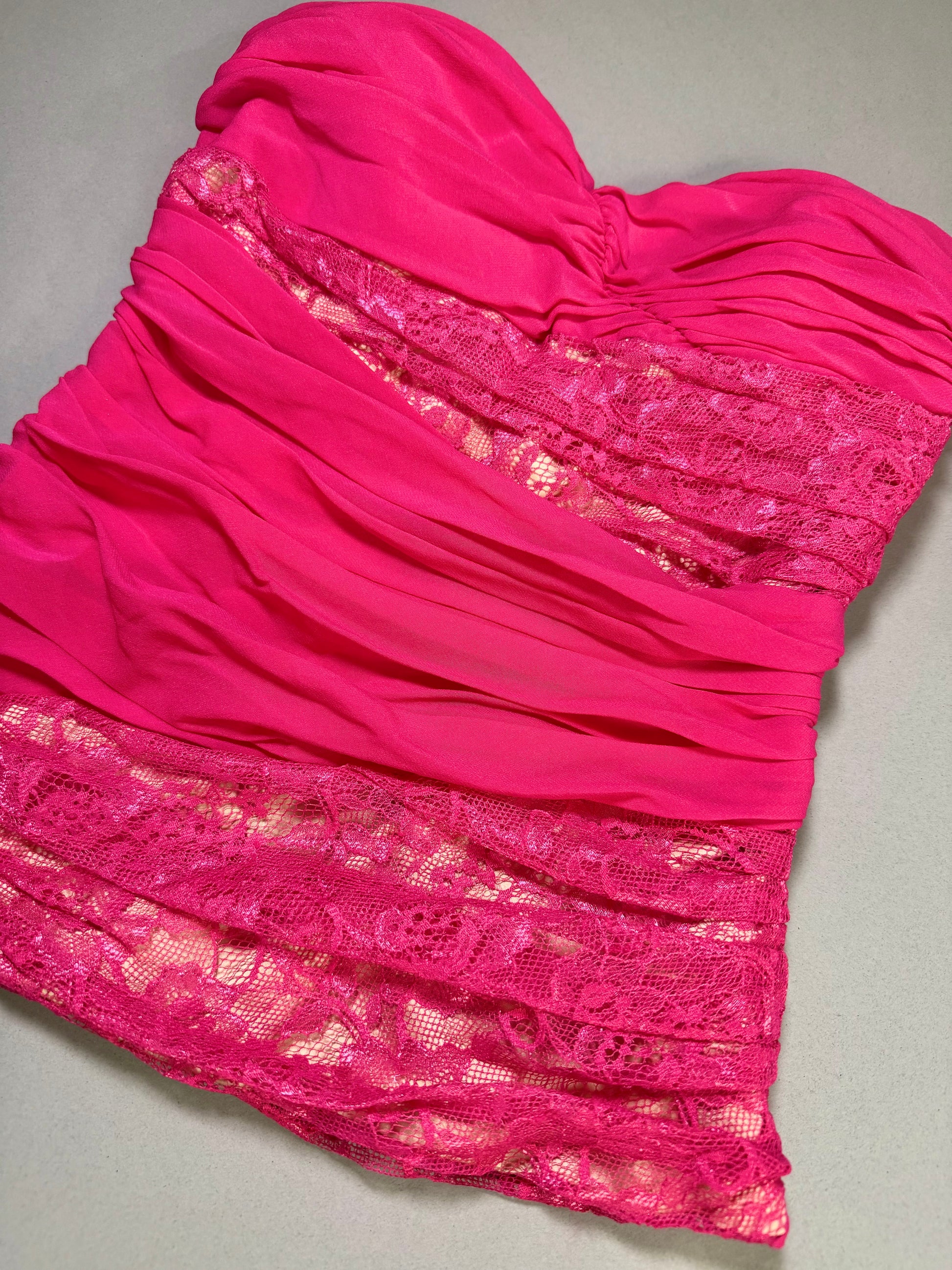 Close-up of the front bodice showing the sweetheart neckline, ruched chiffon, and floral lace panel detailing.