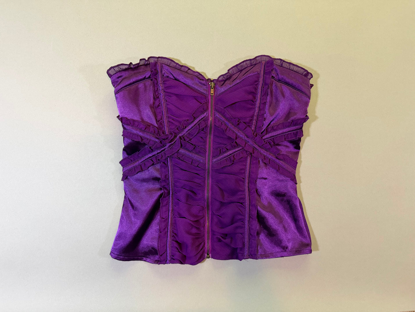 Front of purple silk and chiffon bebe corset top with metal zipper down middle 