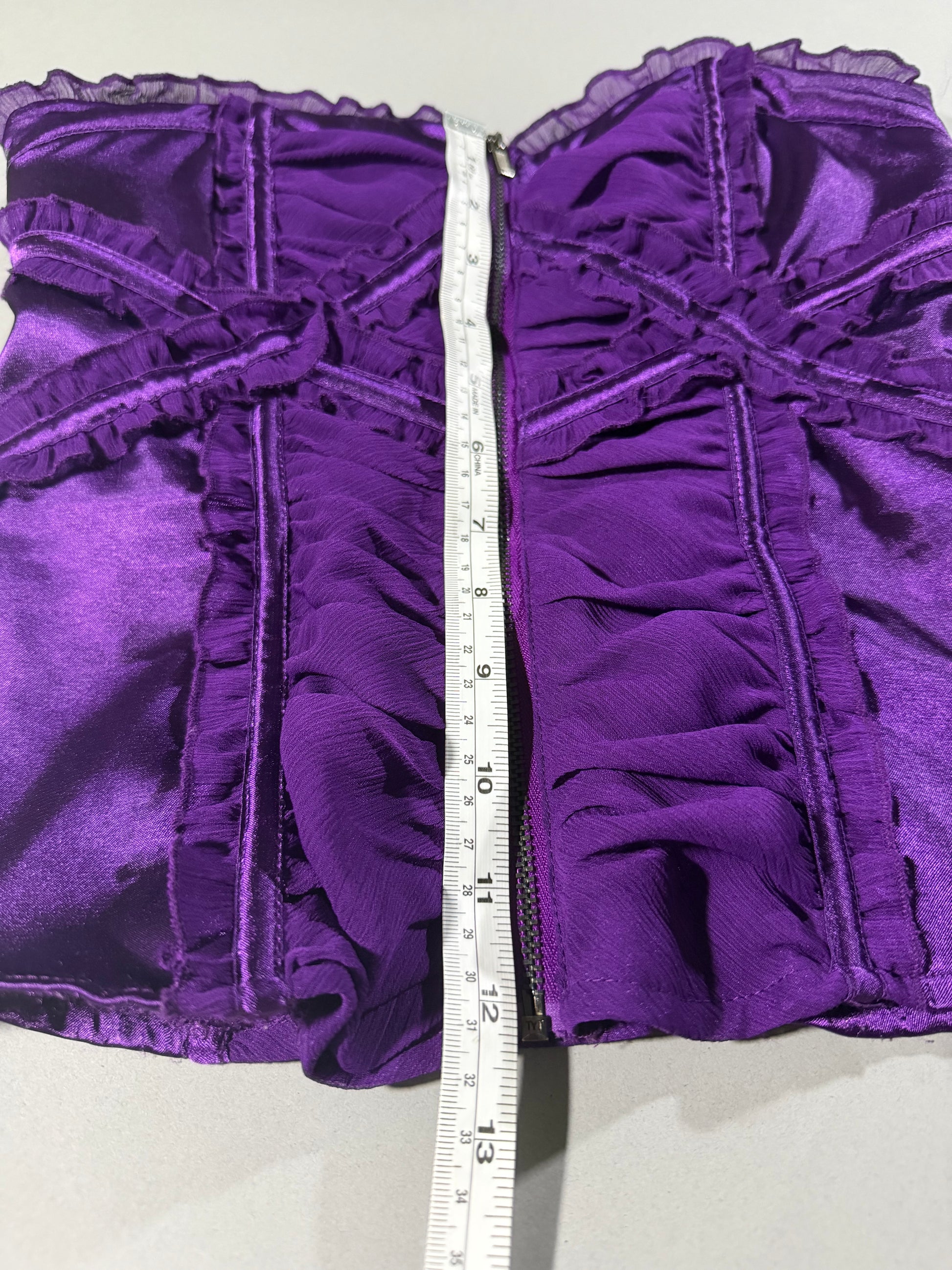 Purple satin and chiffon Bebe top with measuring tape showing 12 inches length