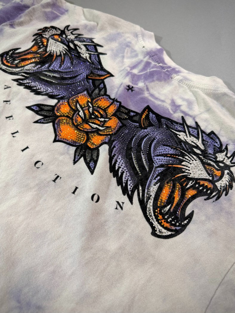 Close-up of the rhinestone tiger heads, orange rose and Affliction lettering on the back graphic.