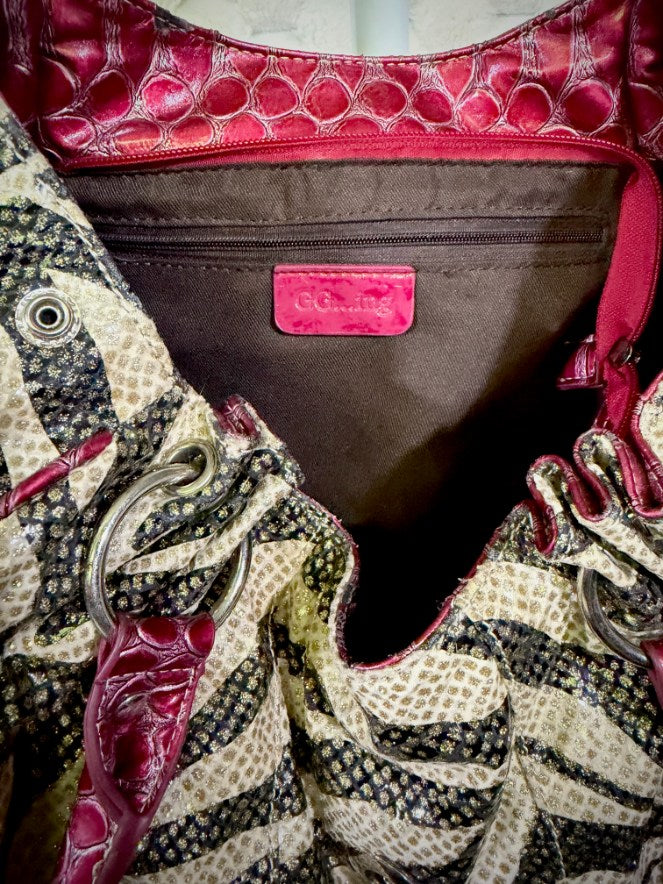Interior brand label and compartment details of zebra print hobo shoulder bag. 