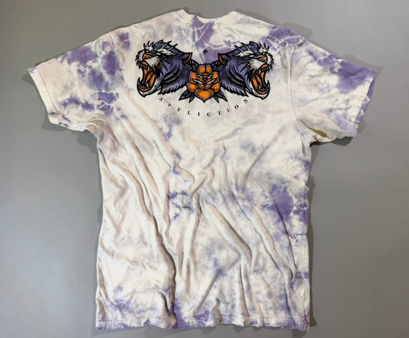 Back of Affliction Black Label purple tie-dye T-shirt with rhinestone twin tiger heads and orange rose graphic across the shoulders.