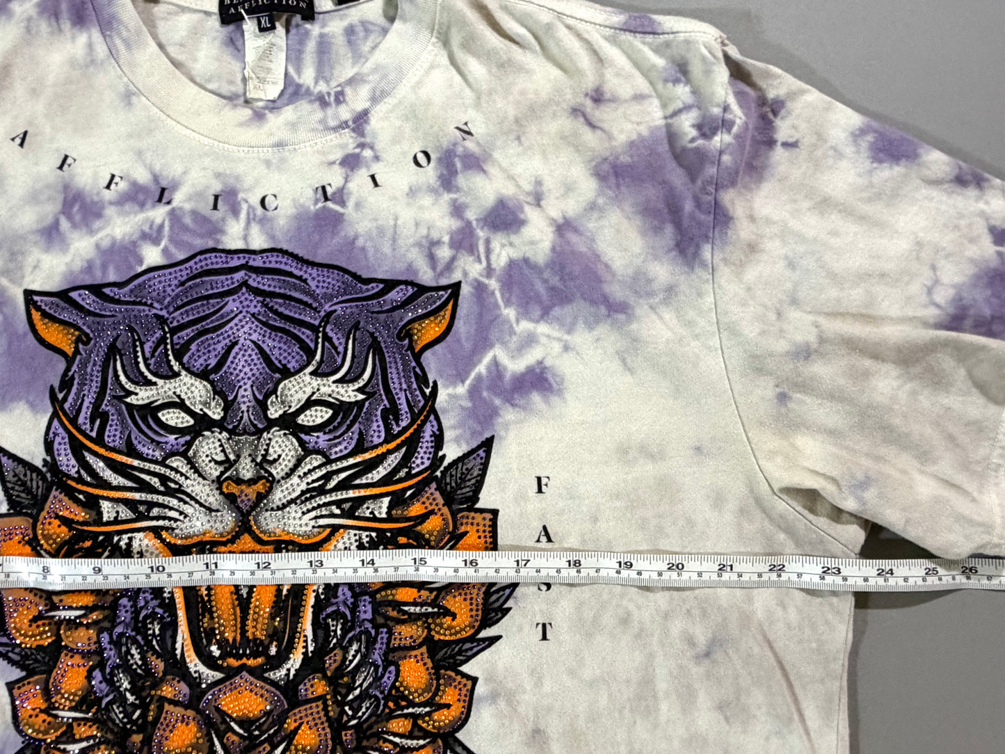 Affliction Black Label XL T-shirt shown with measuring tape across the chest.