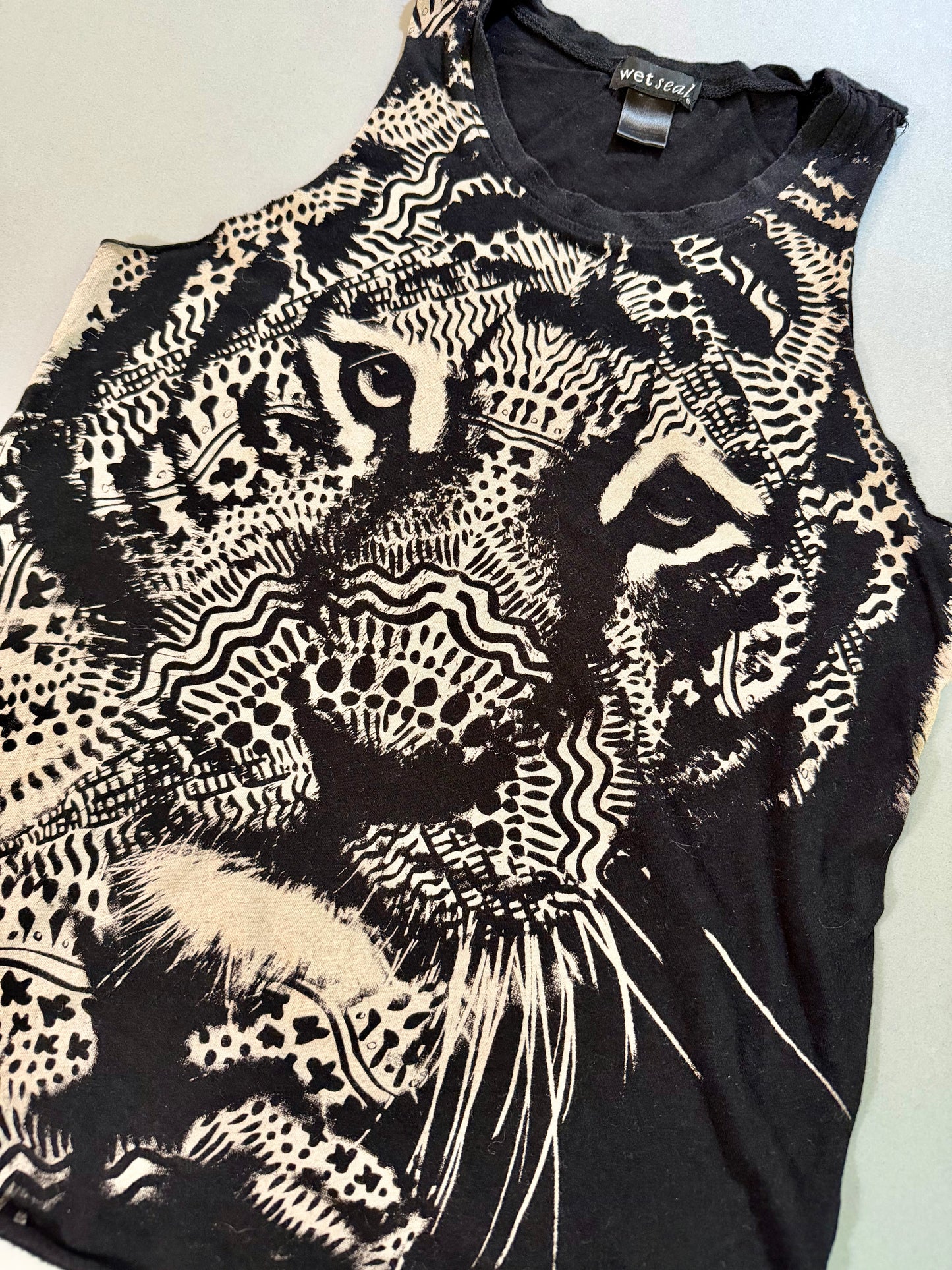 Close-up of the black and cream lion graphic on the Wet Seal tank top.