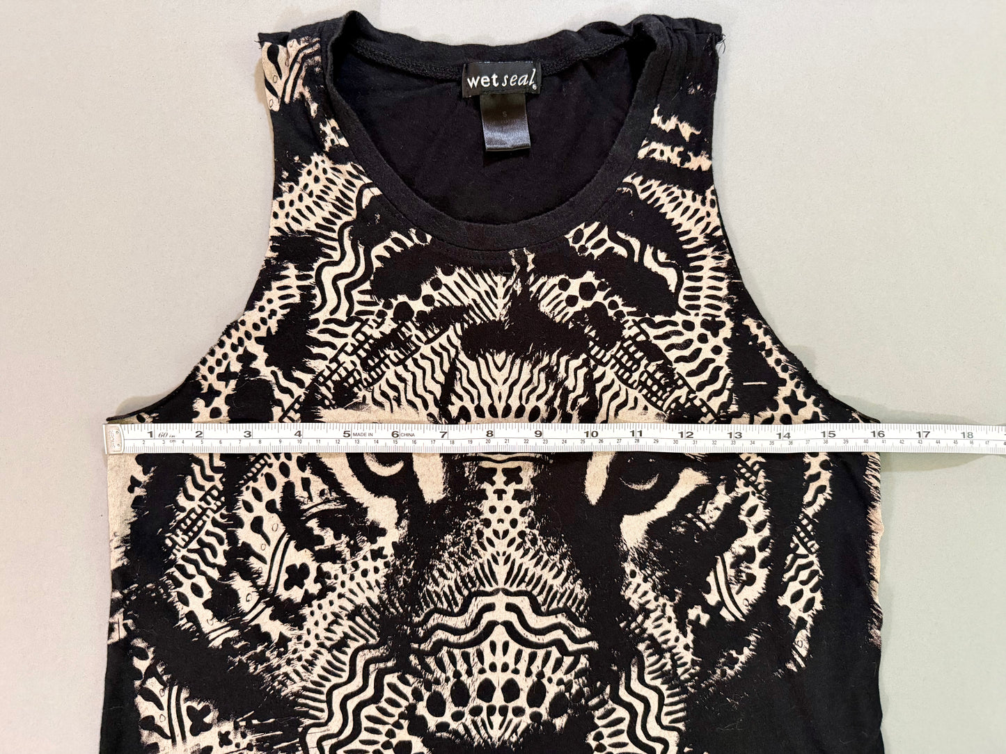 Pit-to-pit measurement shown on the Wet Seal lion graphic sleeveless top.