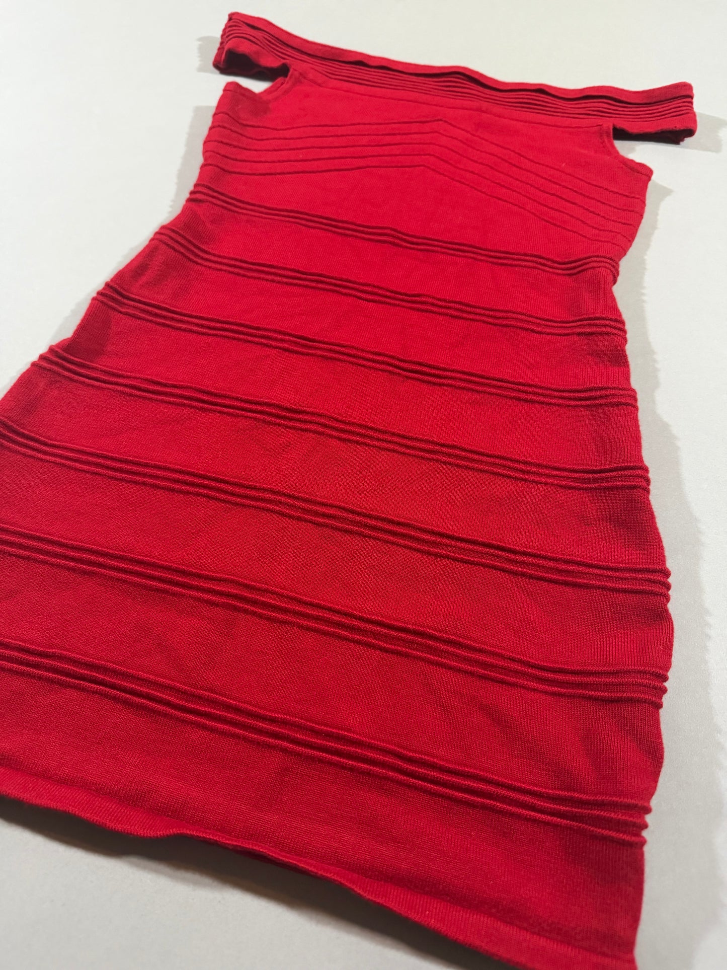 Angled view of the Forever 21 fitted red bodycon dress highlighting the textured ribbed knit and off-the-shoulder neckline