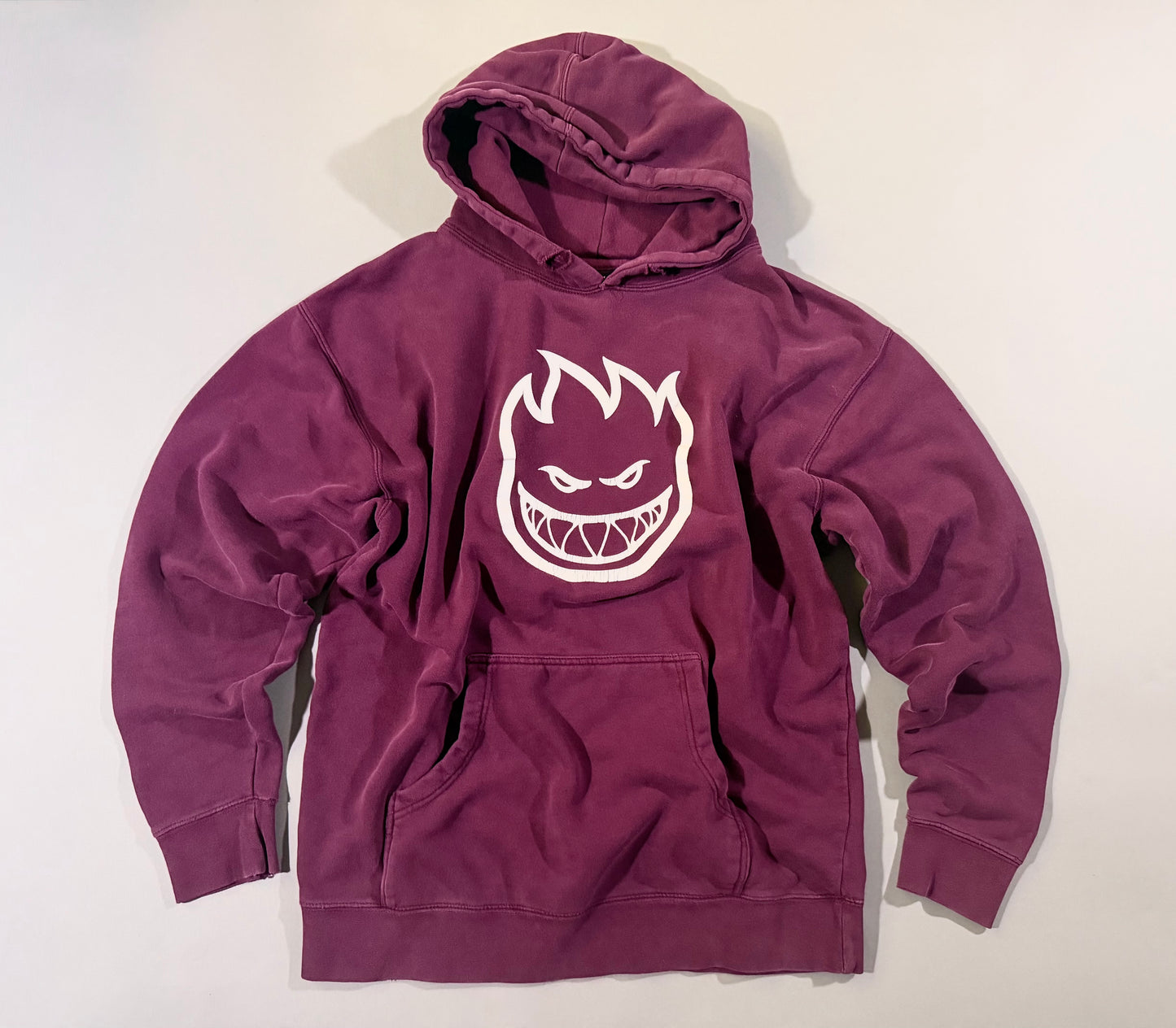 Spitfire Bighead plum purple pullover hoodie with oversized white flame logo laid flat.