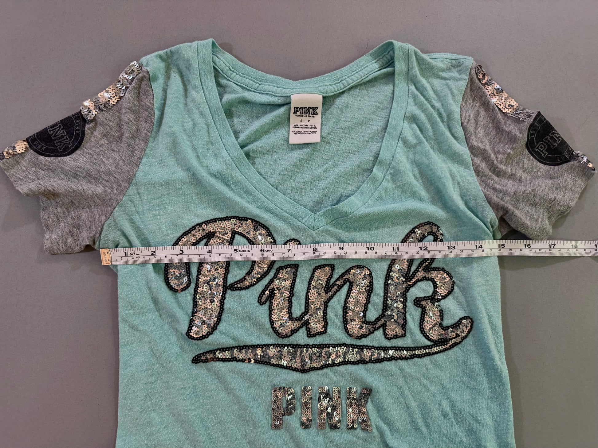 Victoria’s Secret PINK sequin logo T-shirt shown with pit-to-pit measurement.
