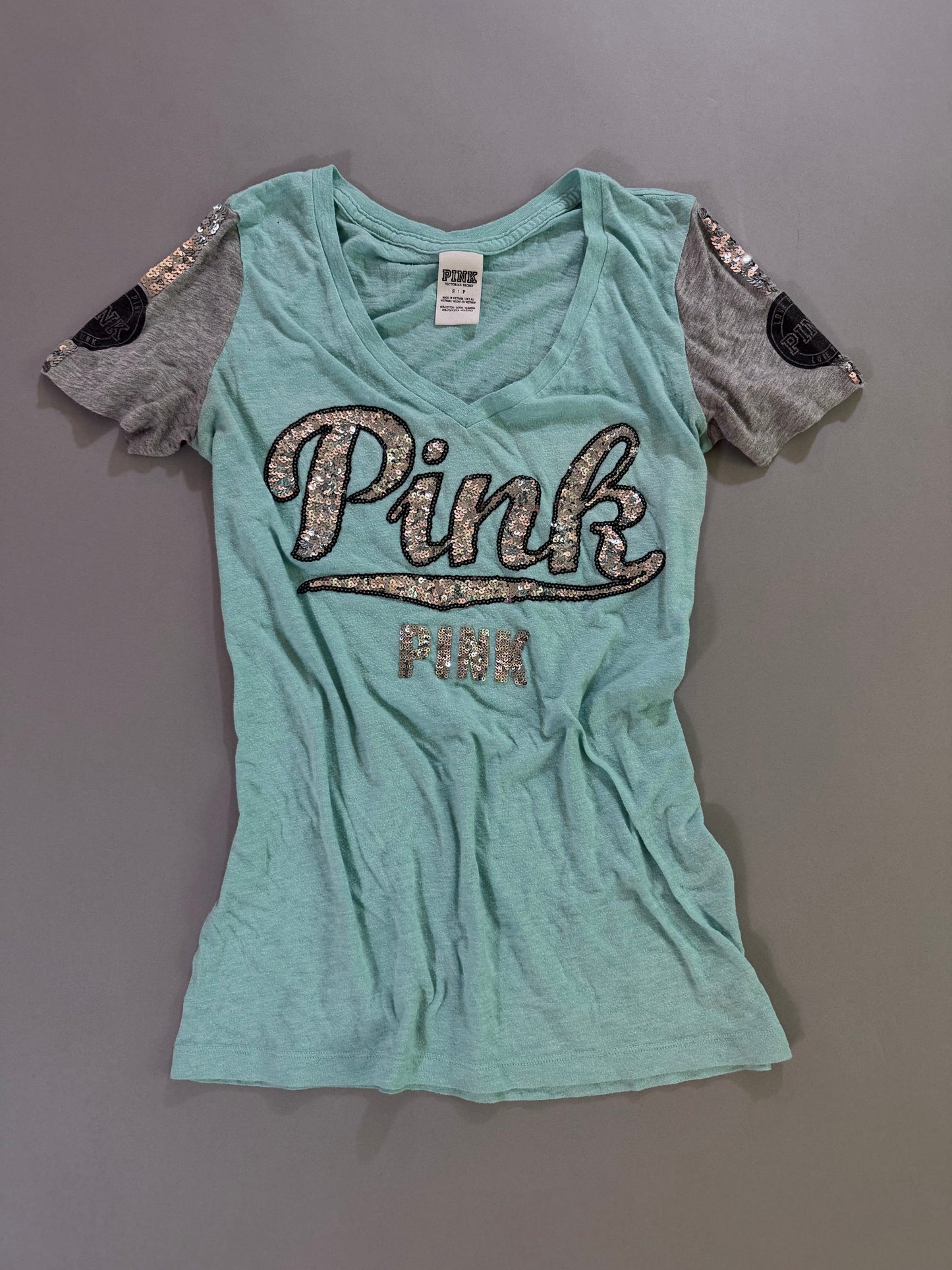 Y2k Victoria’s Secret PINK turquoise burnout V-neck T-shirt with silver sequin logo and gray varsity sleeves.