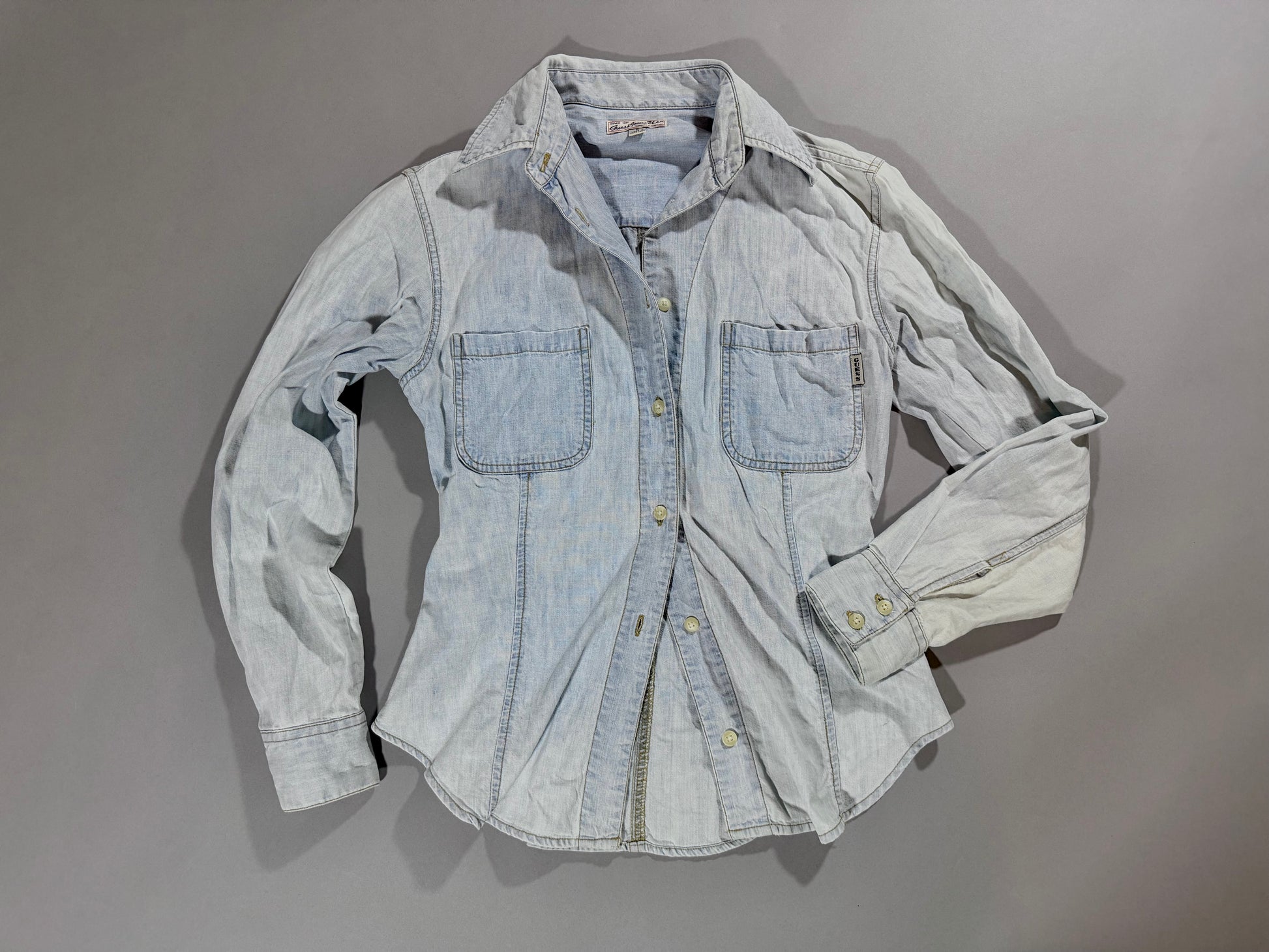Vintage Guess light wash denim button-up shirt styled with an open front.