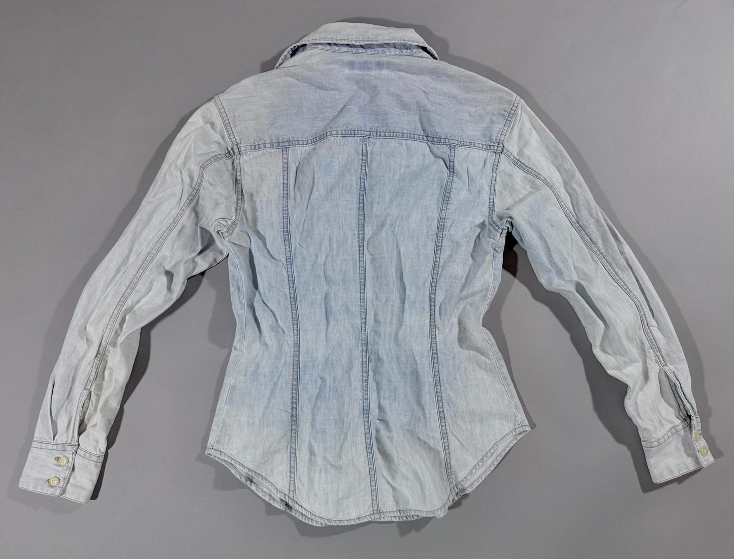 Back view of vintage Guess Jeans Premium Wash light wash chambray button-up shirt.