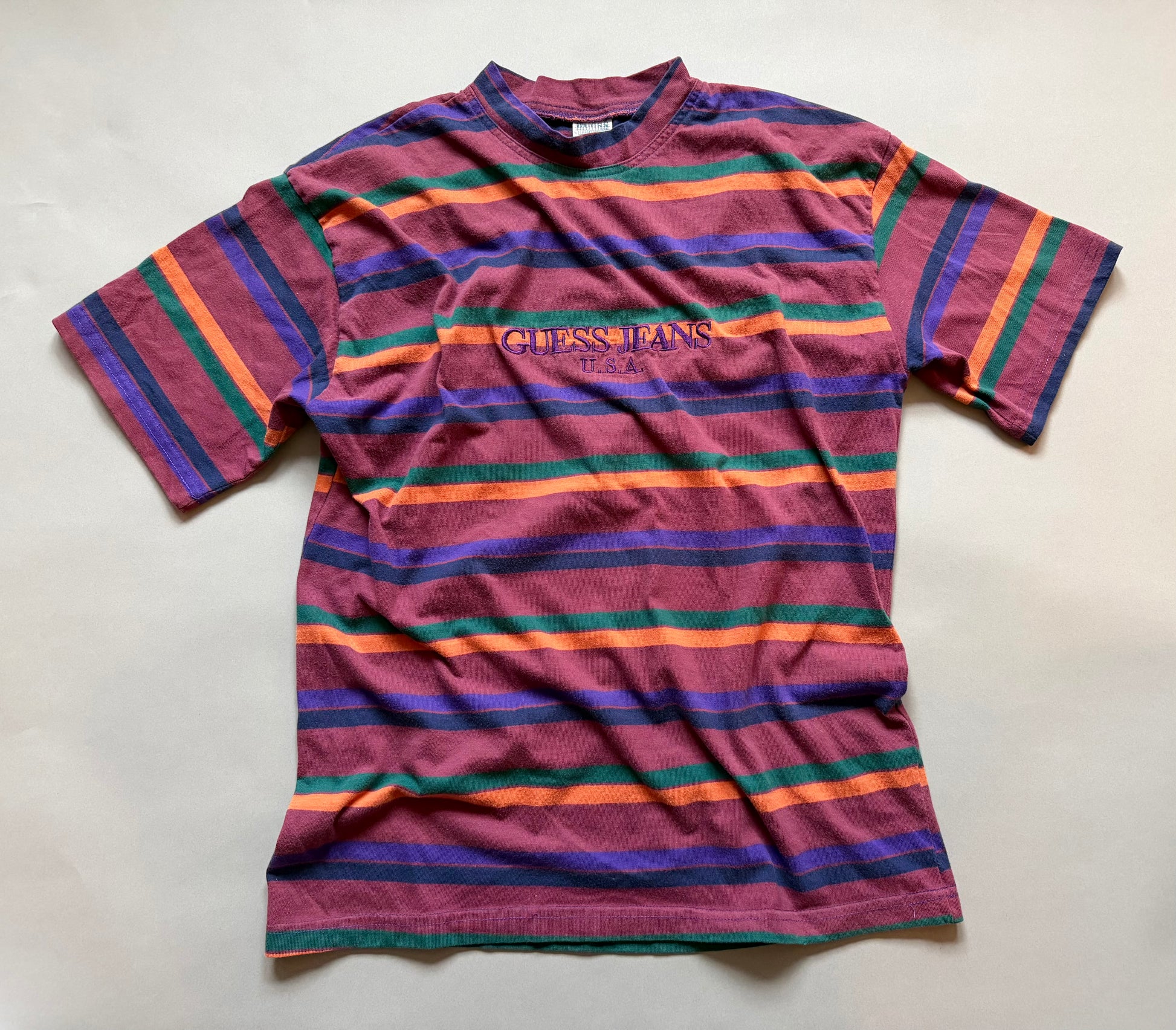 Striped t-shirt with Guess Jeans logo on a light gray background
