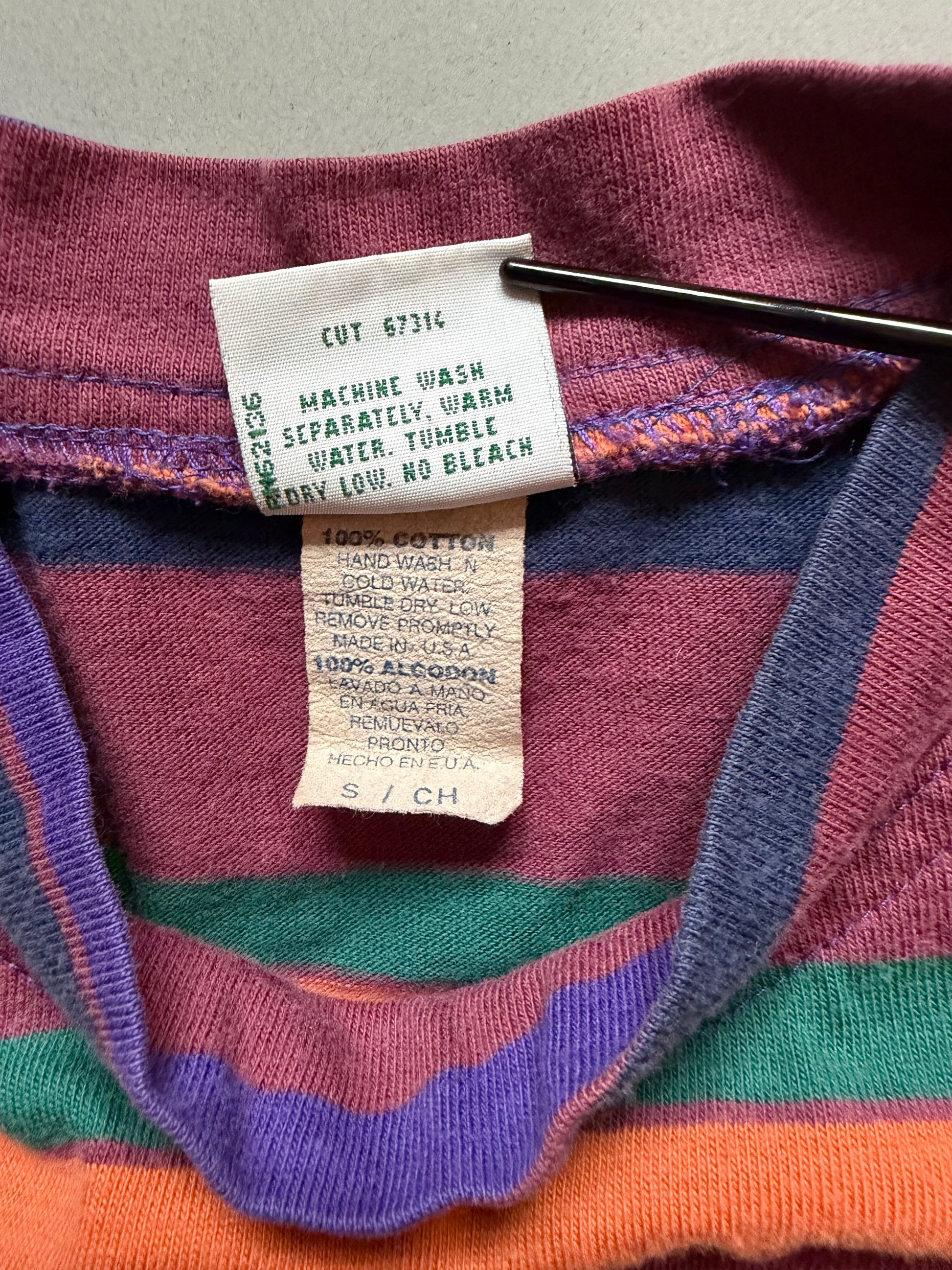 Close-up of vintage 90s striped Guess t-shirt showing label, care tag style tag. 