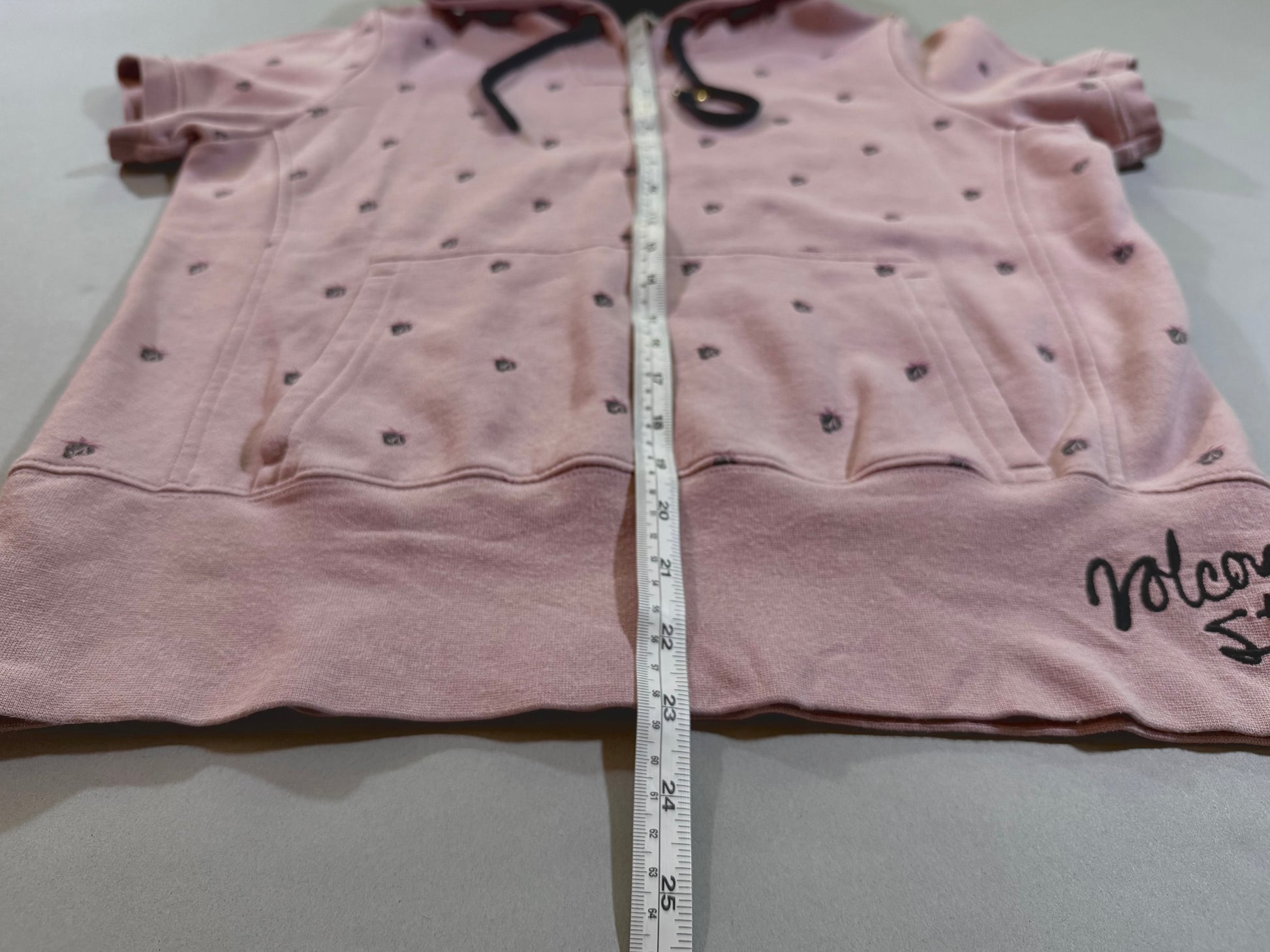 Front view of vintage Volcom hoodie showing overall length, kangaroo pocket, and embroidered Volcom logo at the hem.
